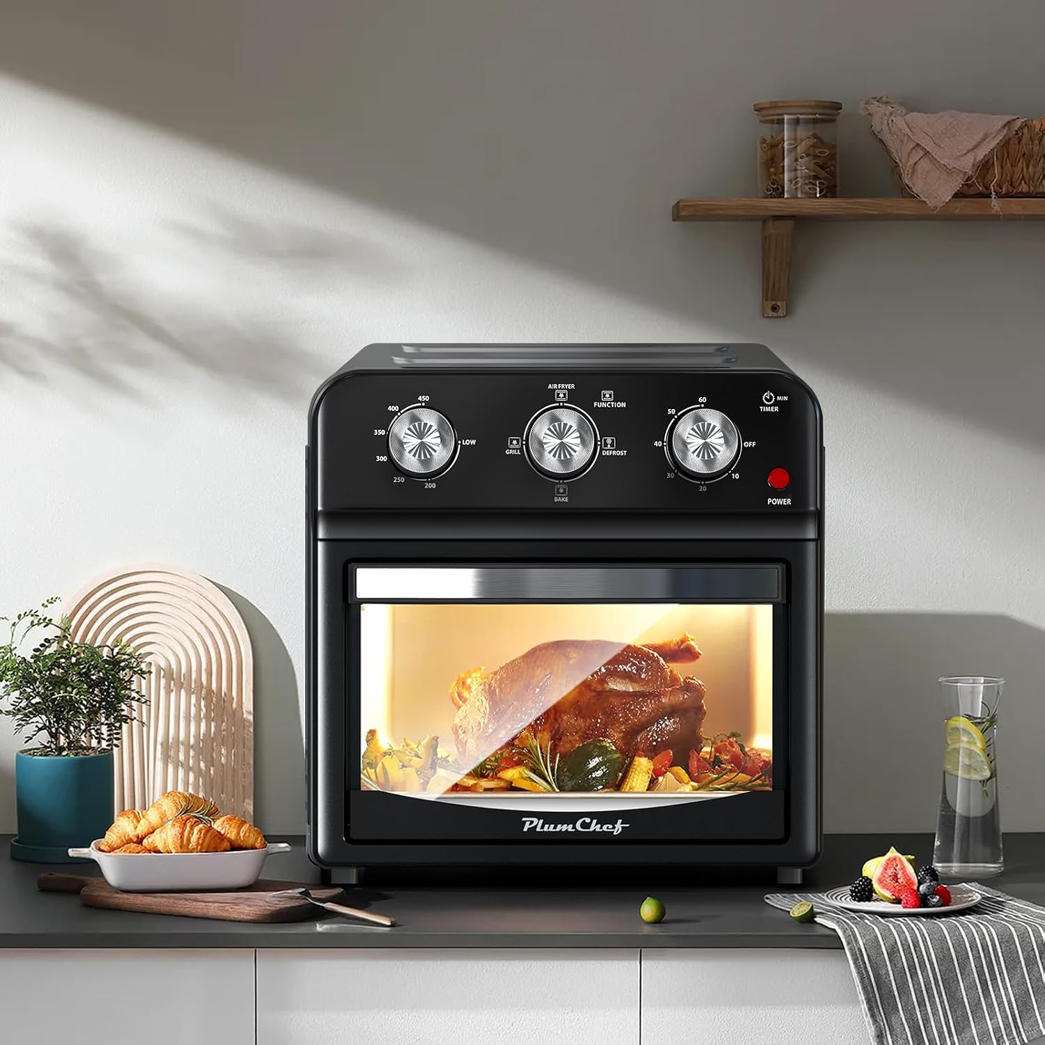 Plum Chef 13QT Air Fryer Convection Oven GA13S-01 placed on a kitchen counter with food items around it.