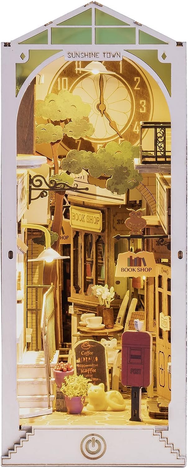 ഫ്രണ്ട് view of the assembled ROBOTIME Sunshine Town Book Nook, highlighting the intricate details of the miniature buildings and street.