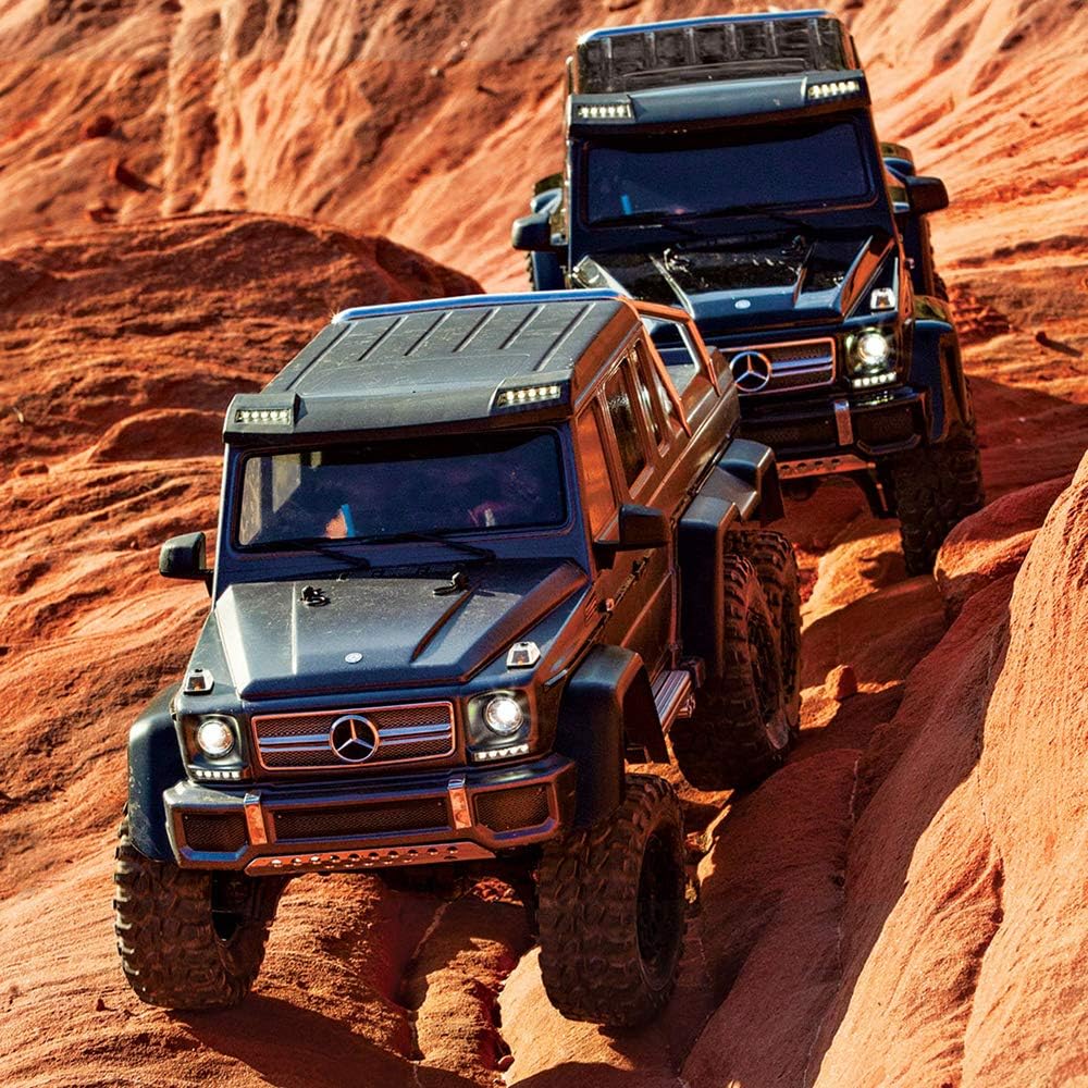 Two Traxxas TRX-6 Mercedes-Benz G 63 RC Crawlers navigating rocky terrain