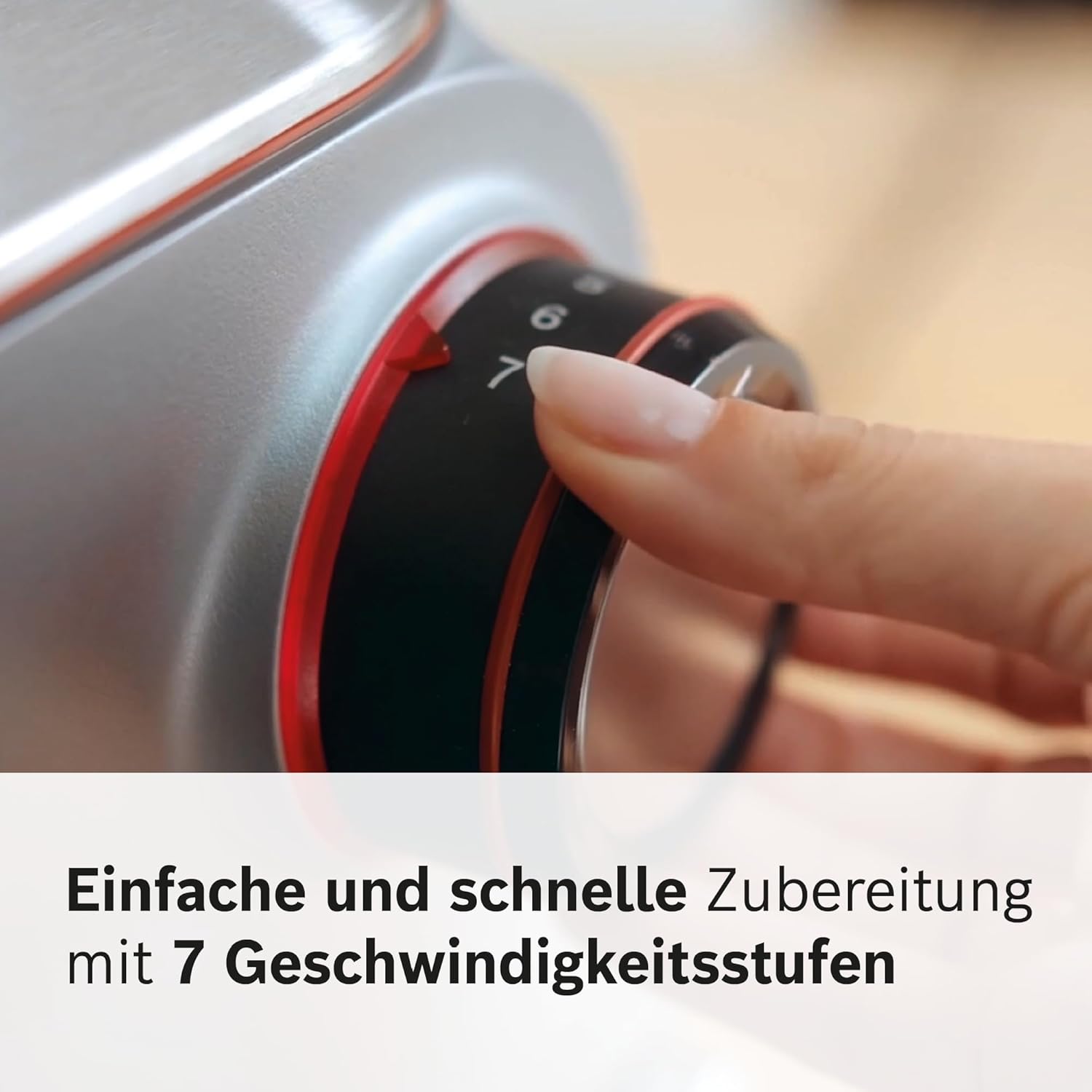 A hand adjusting the 7-speed selector dial on the Bosch OptiMUM food processor.