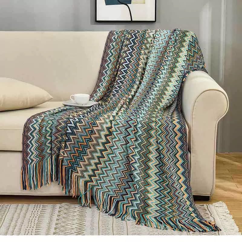 Jeté de canapé tissé d'exception avec pompons pour décoration raffinée