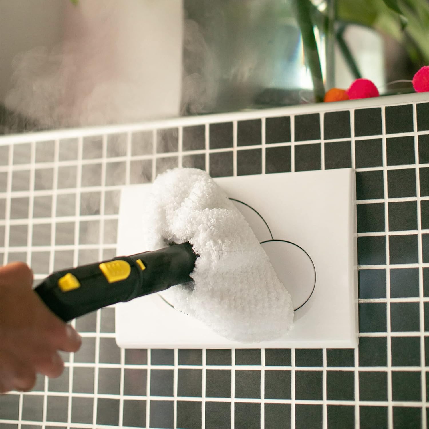 Person using Kärcher SC 3 EasyFix hand nozzle with microfibre cover to clean wall tiles