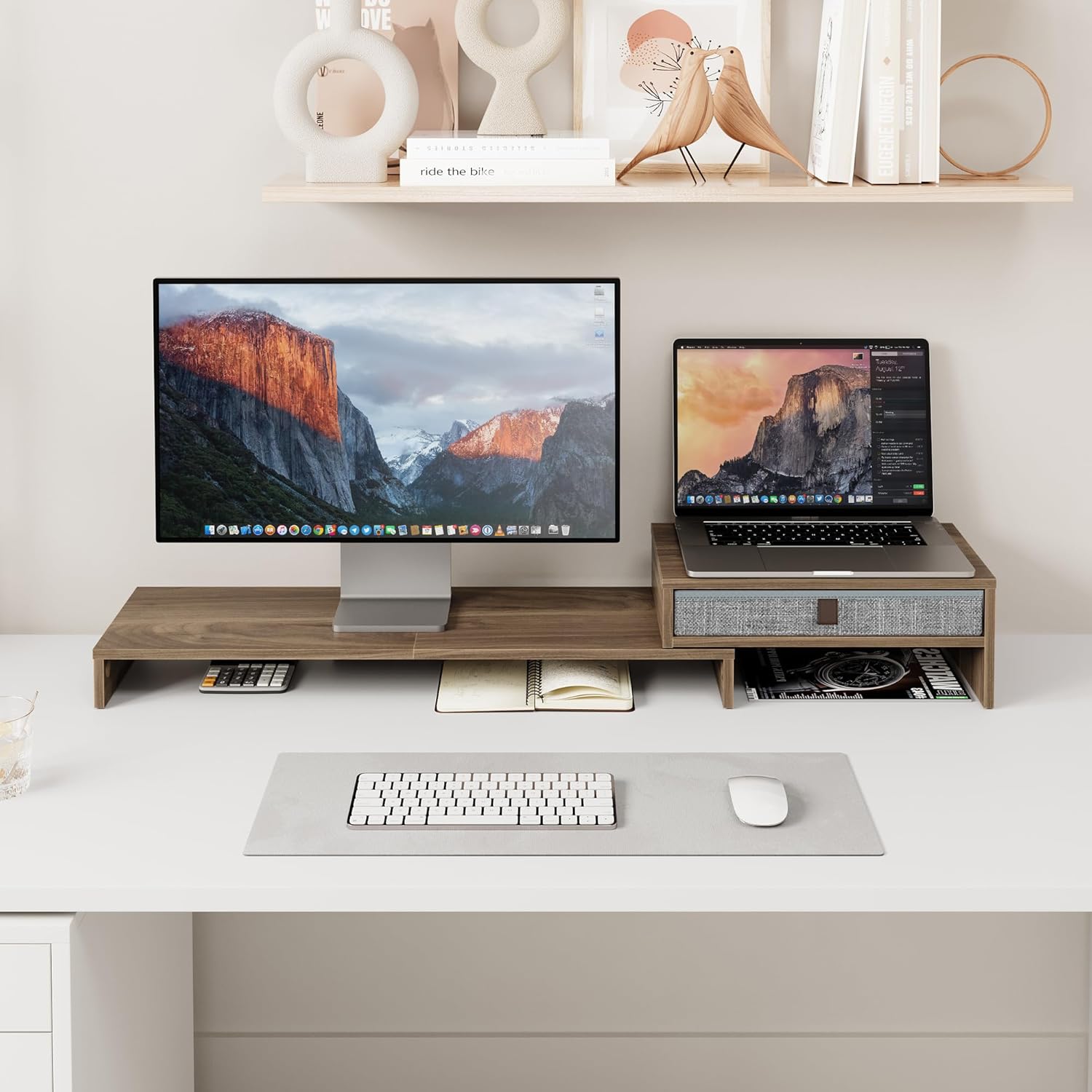 Desk setup with Fenge monitor stand, showing a laptop on one side and a monitor on the other, with items stored underneath