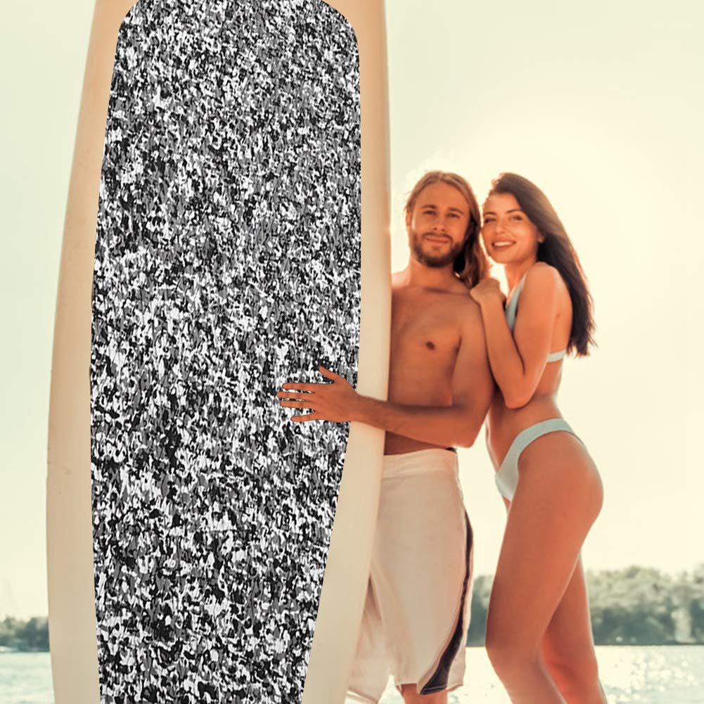 Person carrying a surfboard with the non-slip EVA mat installed