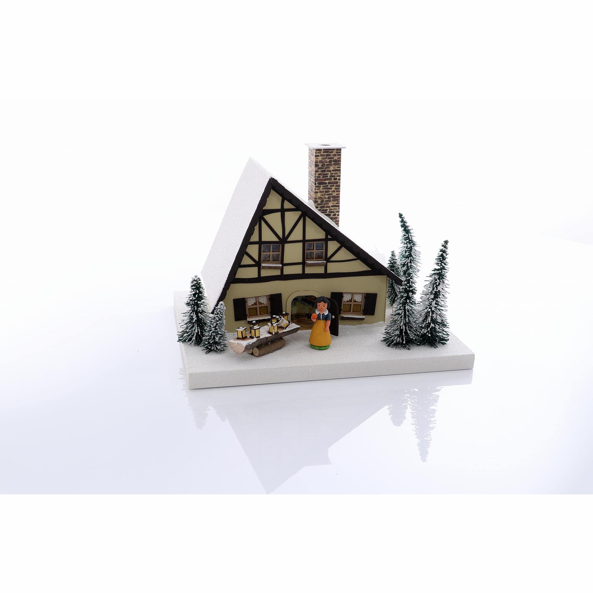 Maison lumineuse à neige souvenirs d'enfance et magie de Noël