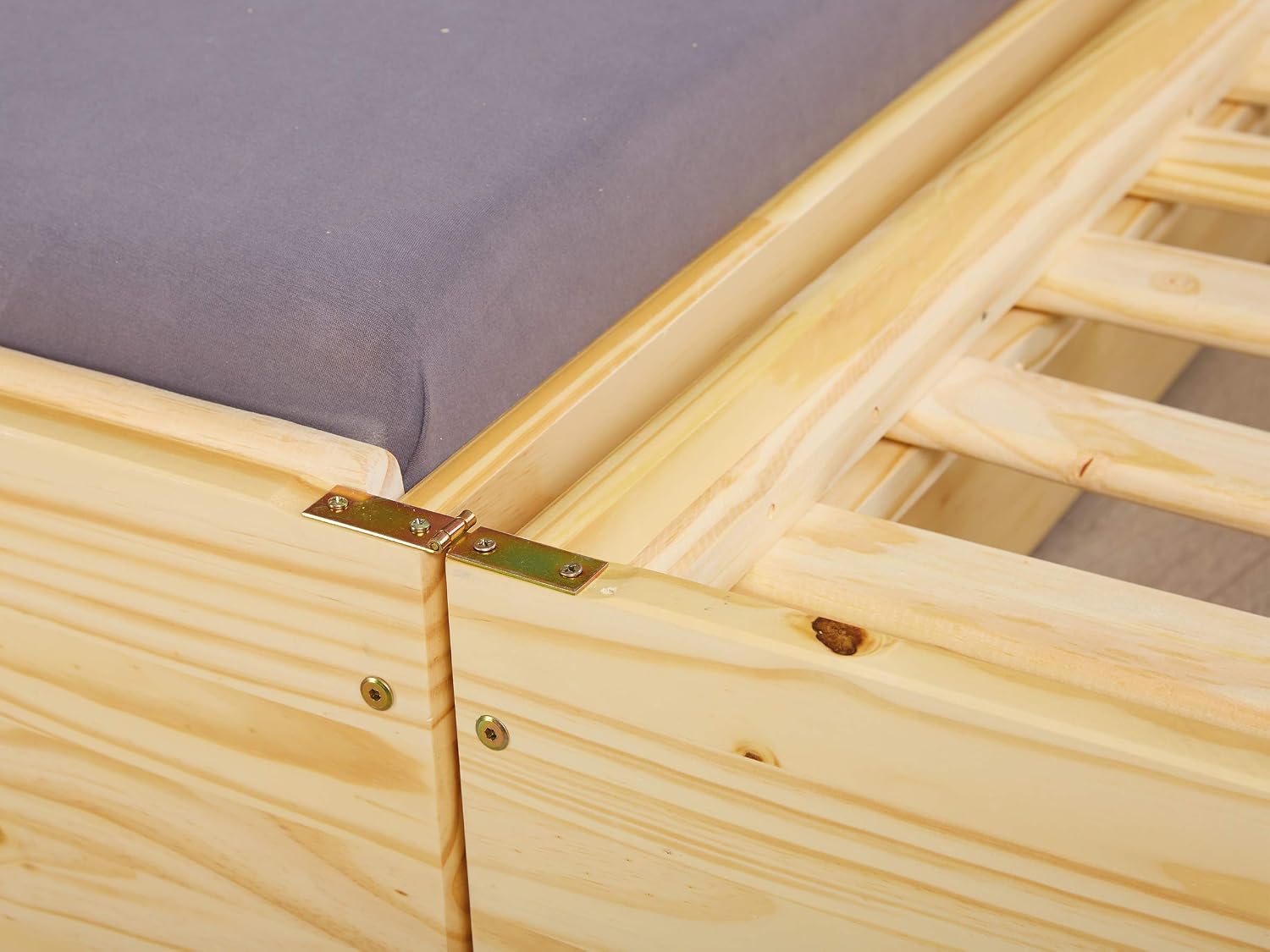 Close-up of the metal hinges connecting the two sections of the bed frame