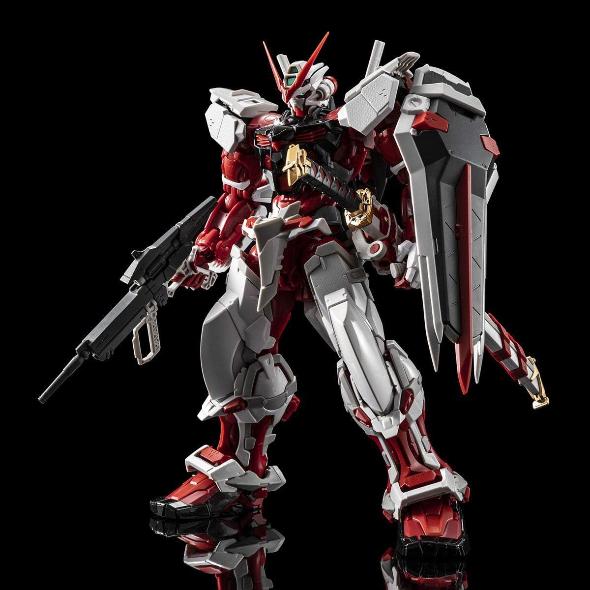 Gundam Astray Red Frame standing with a rifle in one hand and a shield on the other arm.