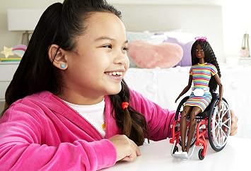 Barbie Fashionistas Doll #166 with Wheelchair & Crimped Brunette Hair Wearing Rainbow-Striped Dress, White Sneakers, Sunglasses & Fanny Pack, Toy for Kids 3 to 8 Years Old