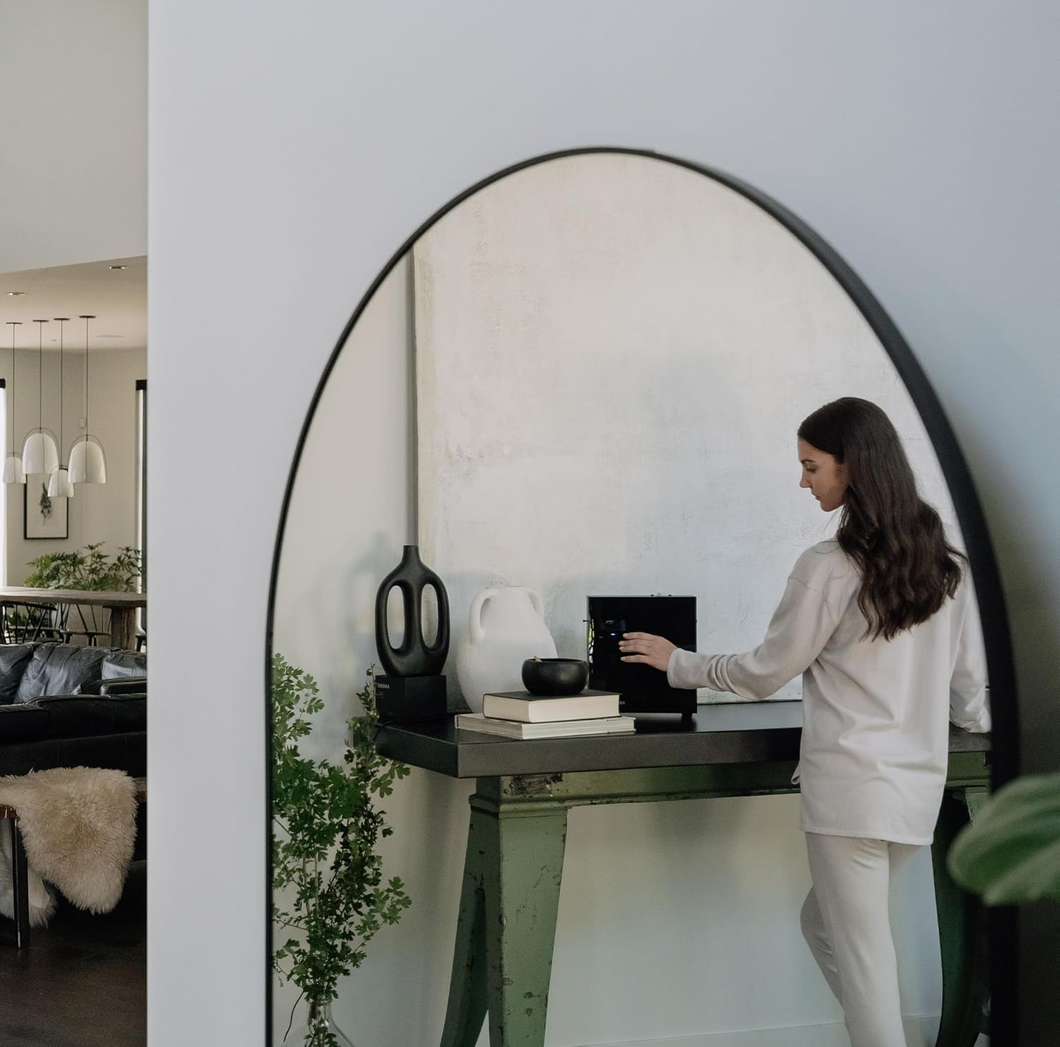 A person adjusting settings on the AromaTech AromaPro diffuser's control panel