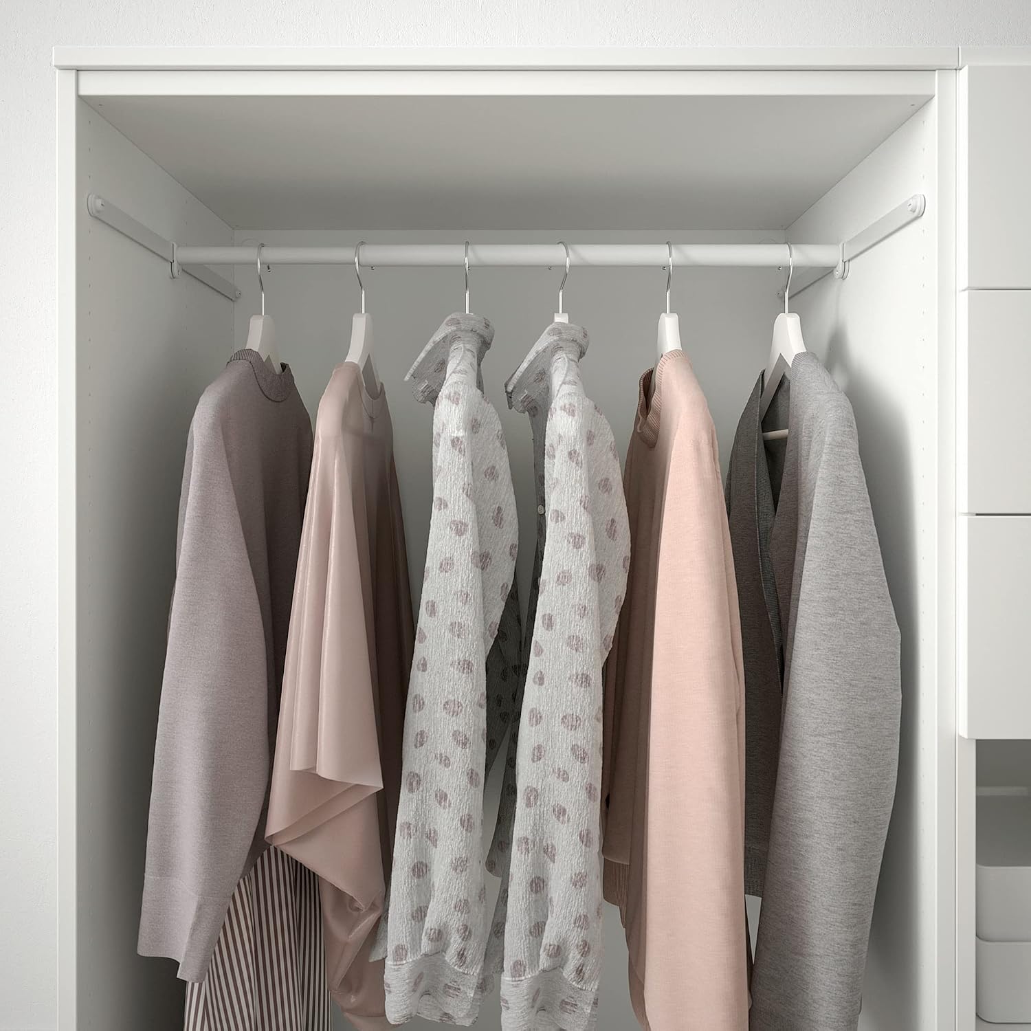 Close-up of a hanging rail inside the PLATSA wardrobe with various garments