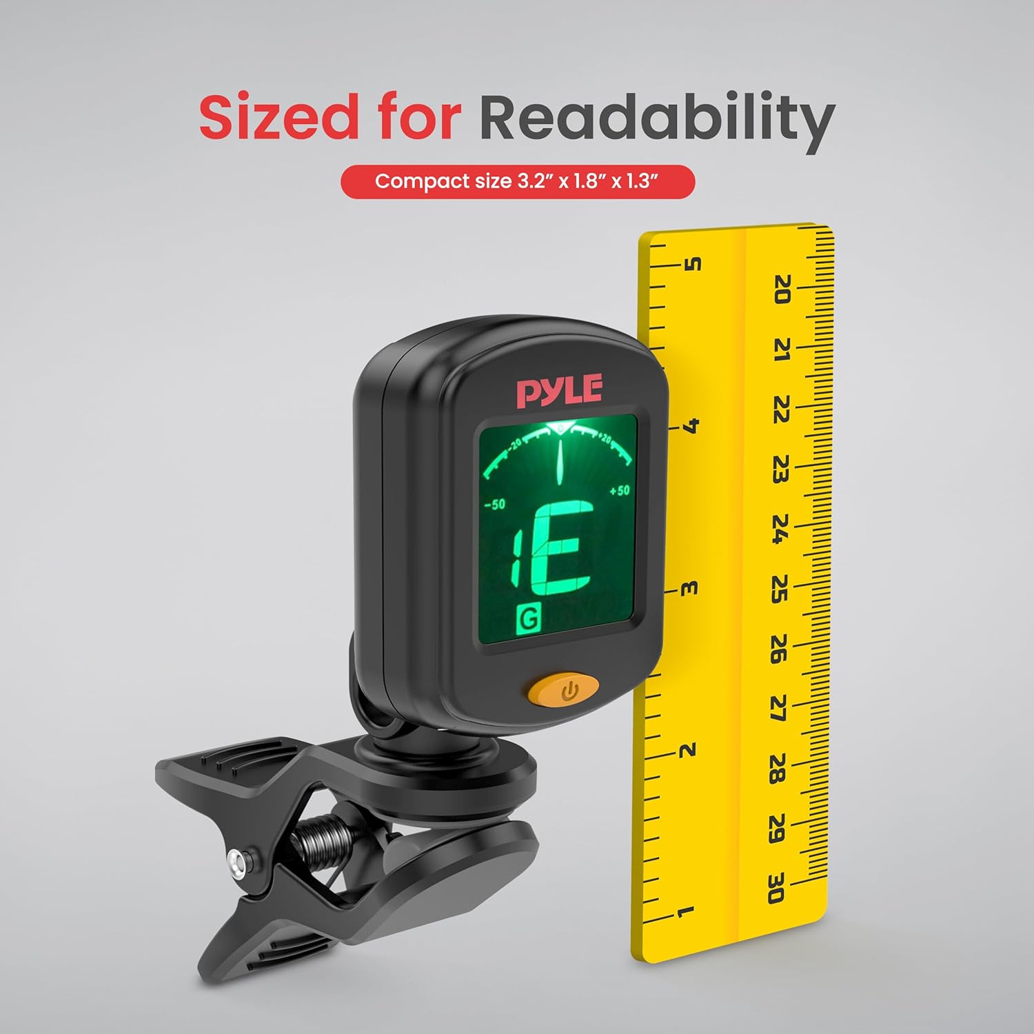 Pyle Digital Clip-On Chromatic Tuner next to a ruler, demonstrating its compact size