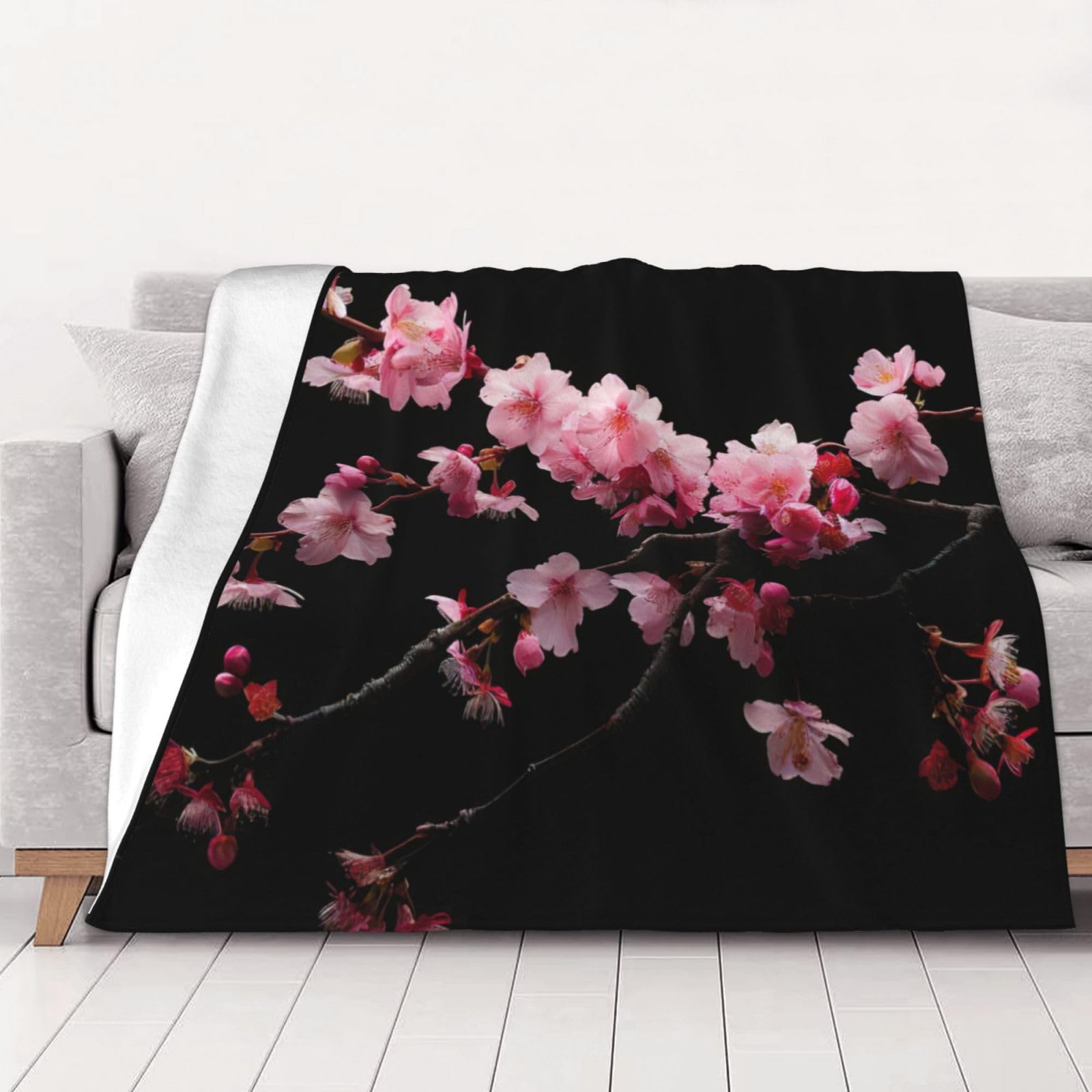 Couverture flanelle fleurs de cerisier finie la fraîcheur sur le canapé