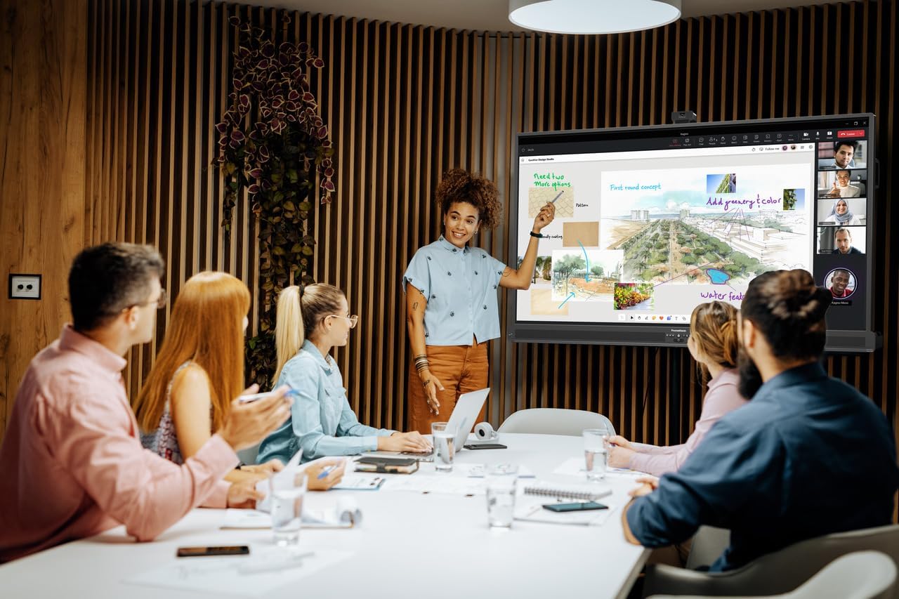 A group of diverse professionals collaborating around a Promethean ActivPanel 10 in an office, with one woman pointing at the screen.