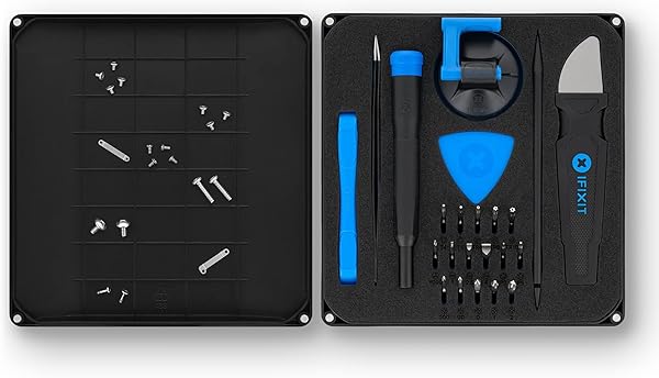 The iFixit Essential Electronics Toolkit laid out, showcasing the screwdriver, 16 precision bits, and various opening tools.