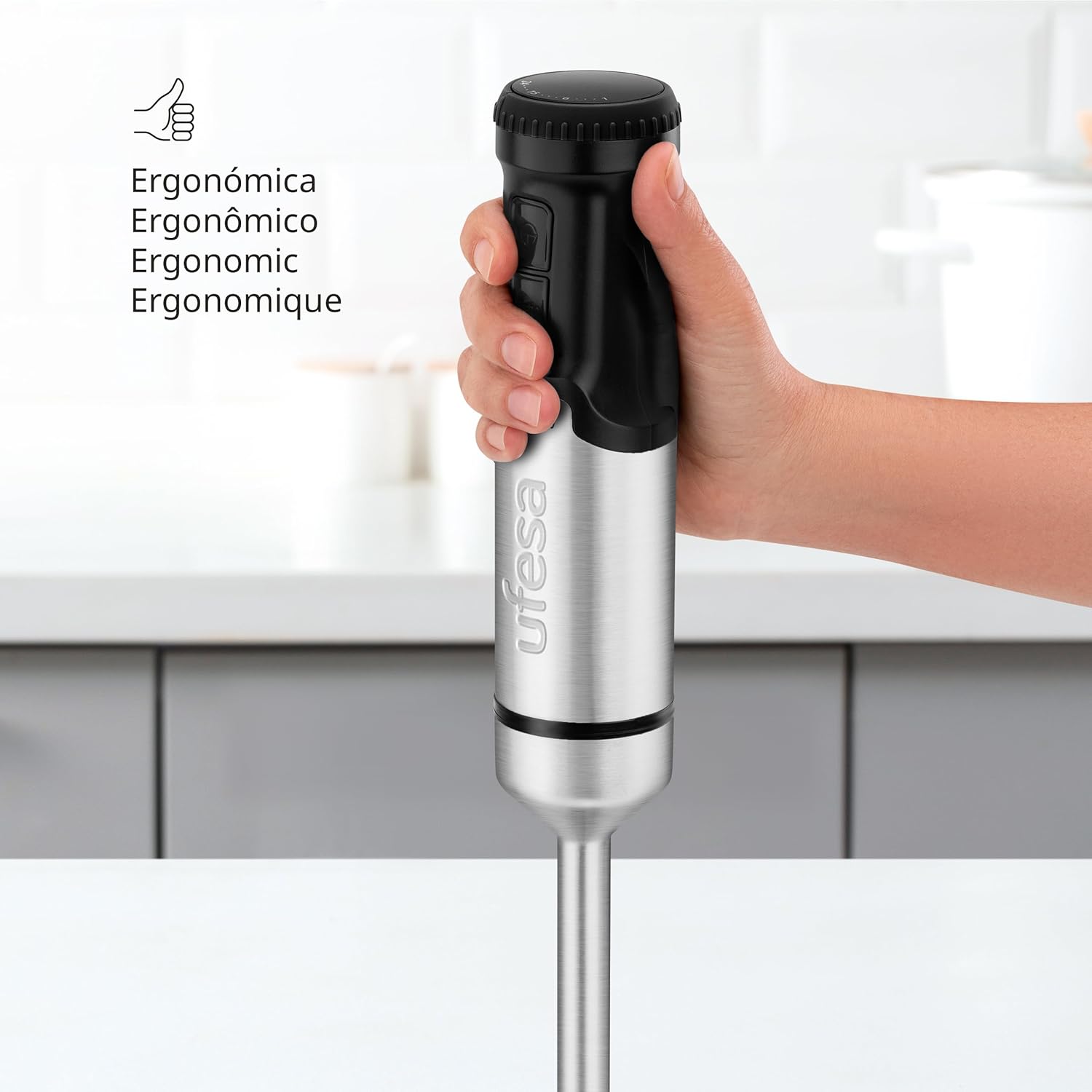 Hand holding Ufesa Galaxy Hand Blender, showing ergonomic grip