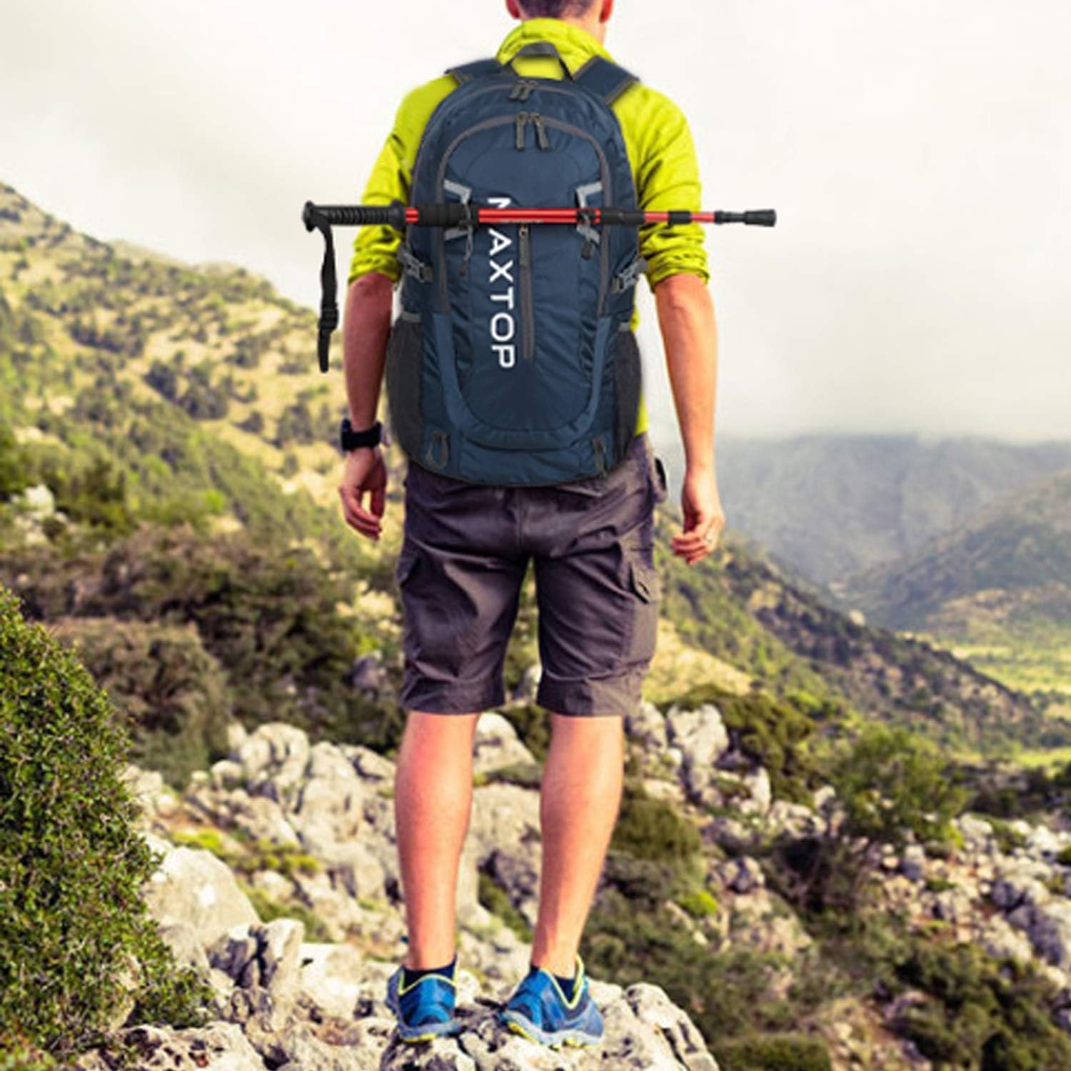 A person wearing the MAXTOP hiking backpack on a mountain trail, demonstrating its use during outdoor activities.
