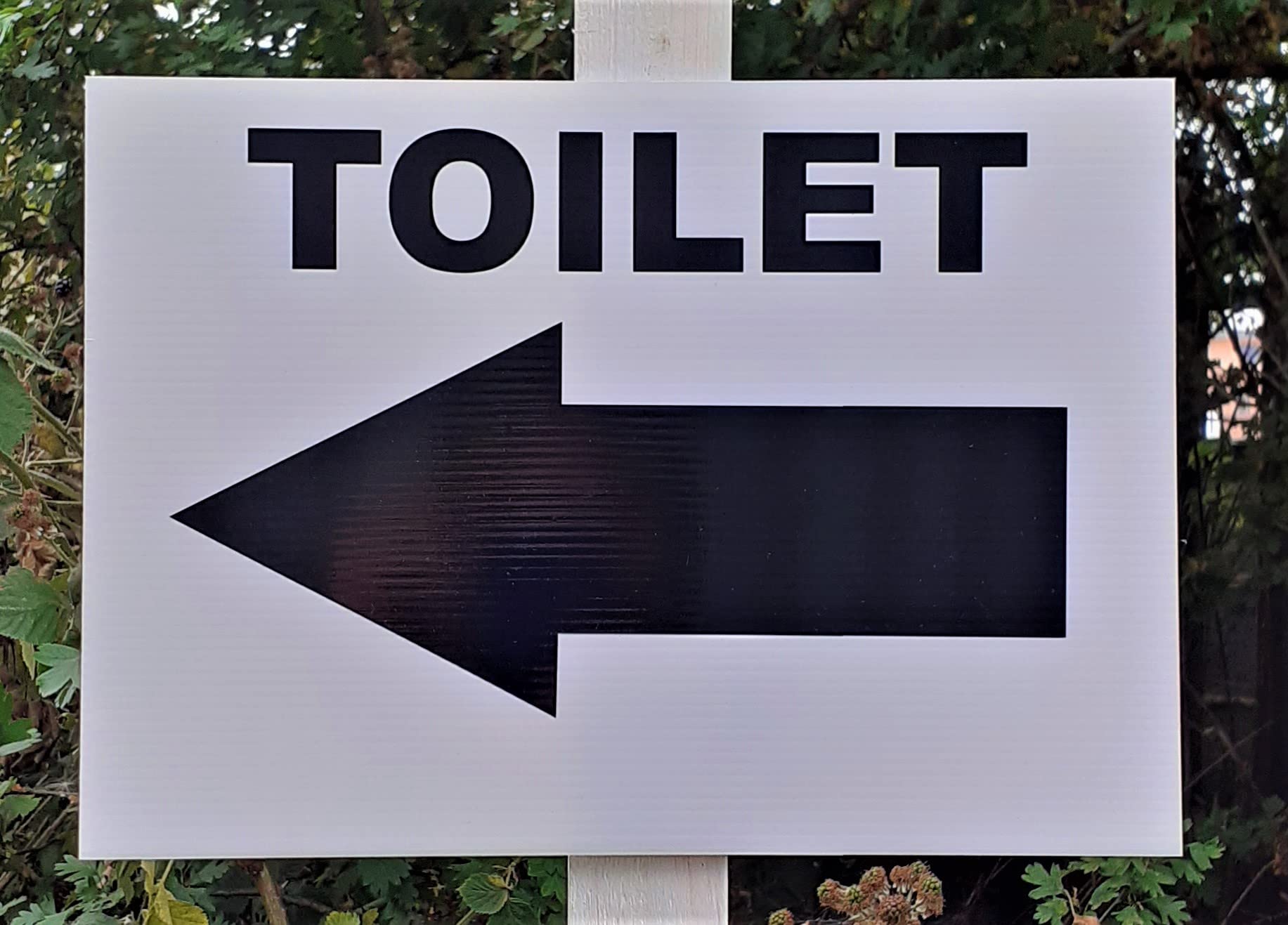 Toilet and arrow left symbol - Direction Signs 297 x 210mm exterior grade Notice. 4mm white fluted polyprop light but durable.