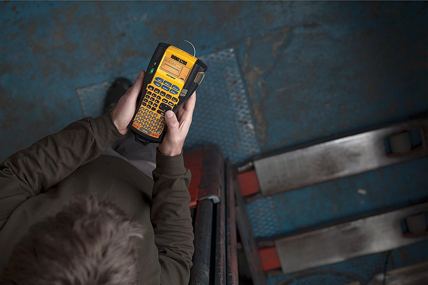 Overhead view of a person holding a DYMO RhinoPRO 5200 label maker