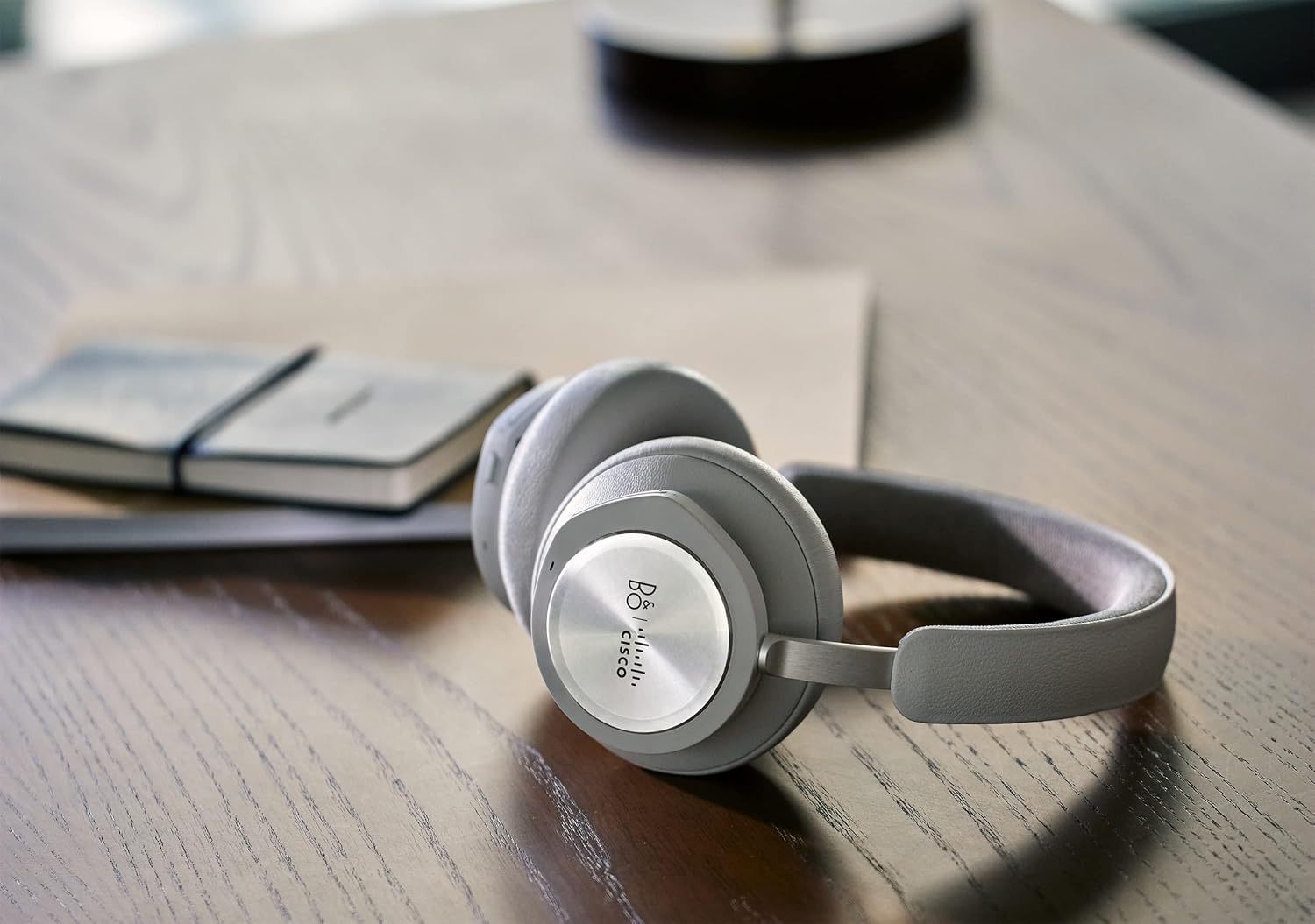 Cisco Bang & Olufsen Cisco 980 headset resting on a wooden desk