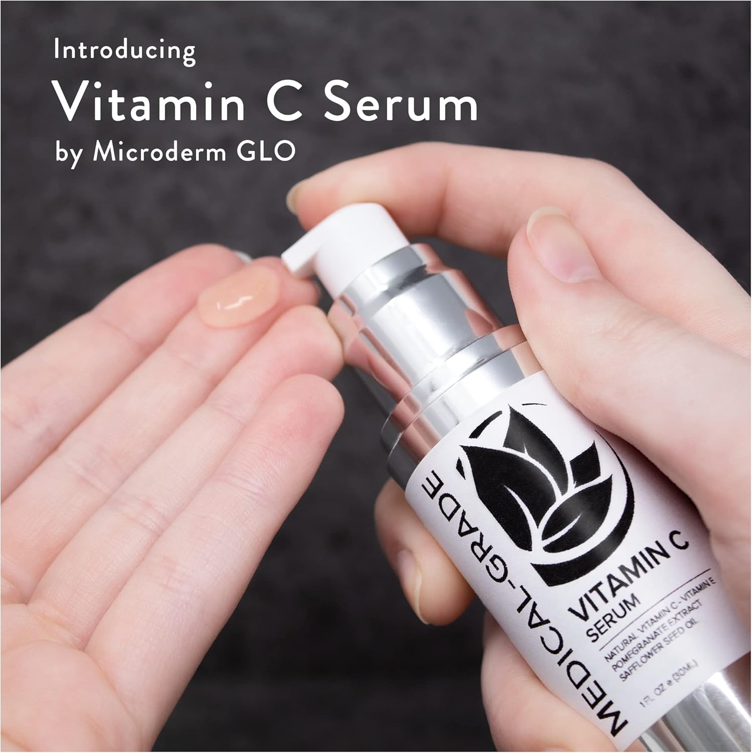 Hand applying Microderm GLO Vitamin C Serum to face