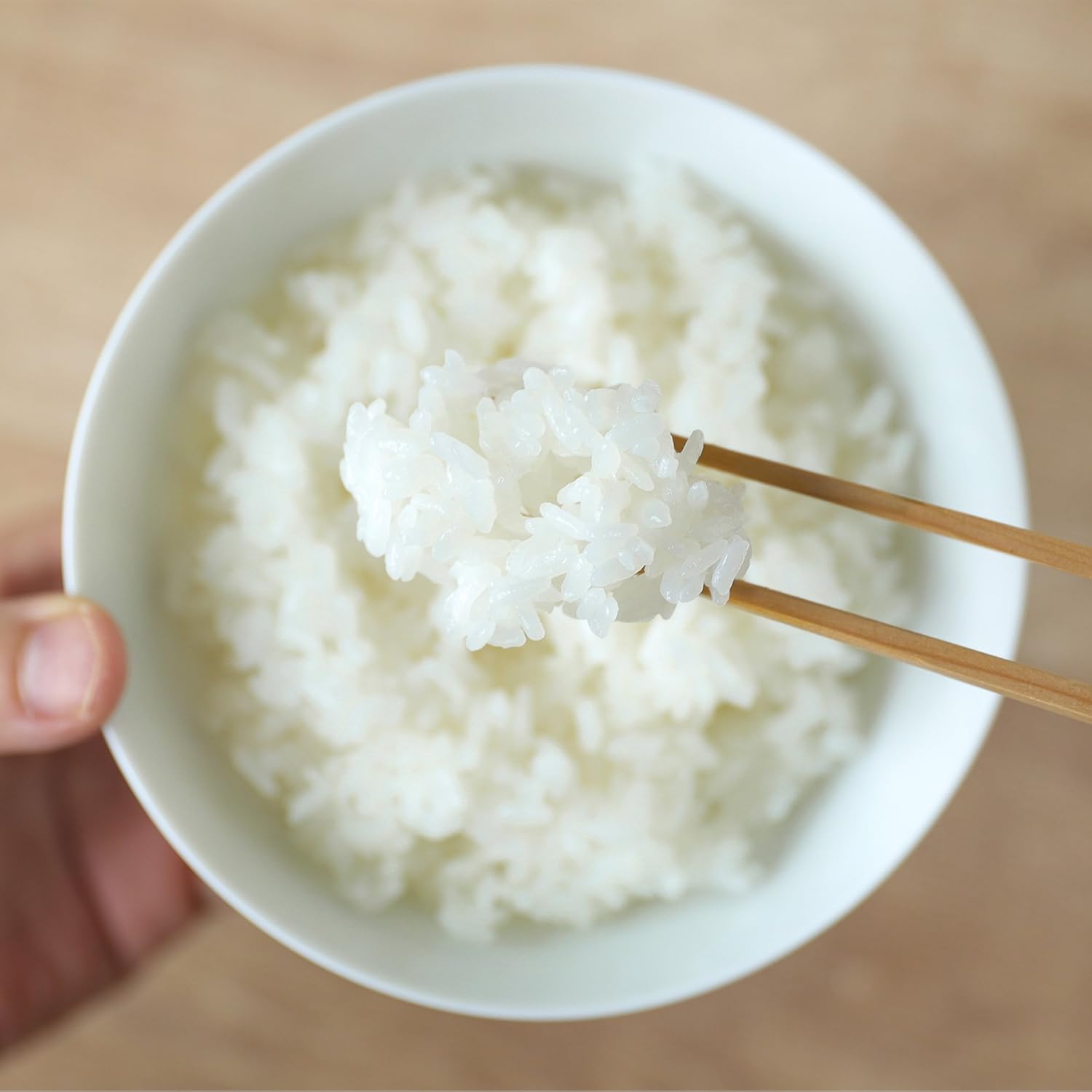Bowl of perfectly cooked white rice with chopsticks