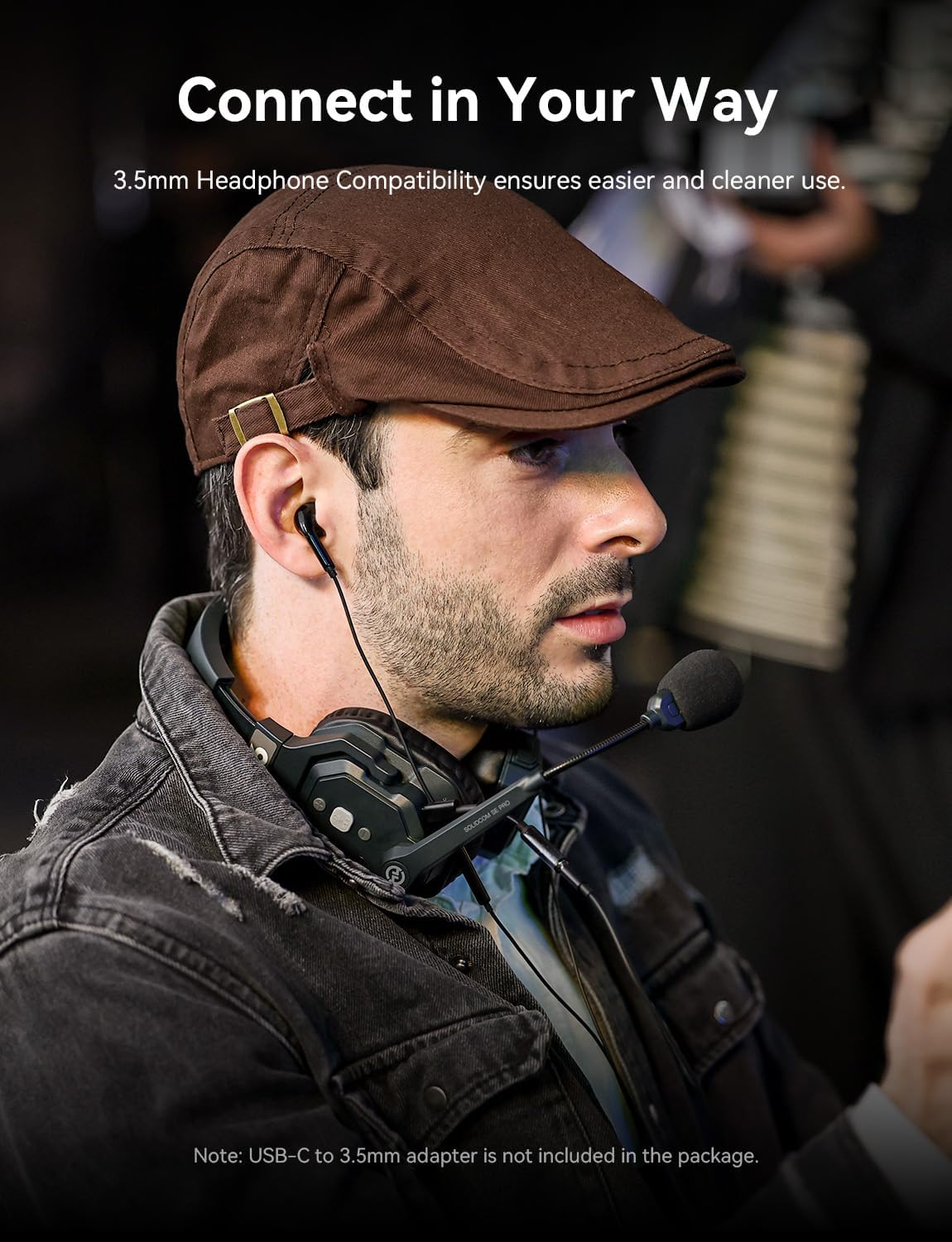 User wearing a Solidcom SE PRO headset with a 3.5mm earbud connected, demonstrating headphone compatibility.