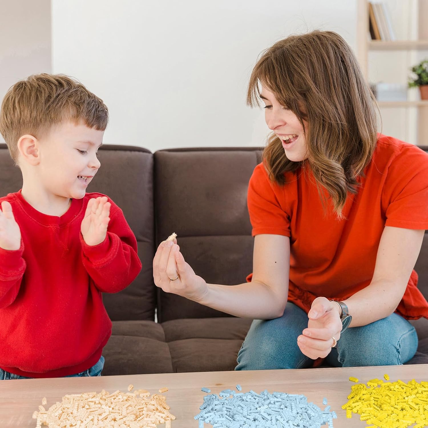 Adult and child assembling micro building blocks