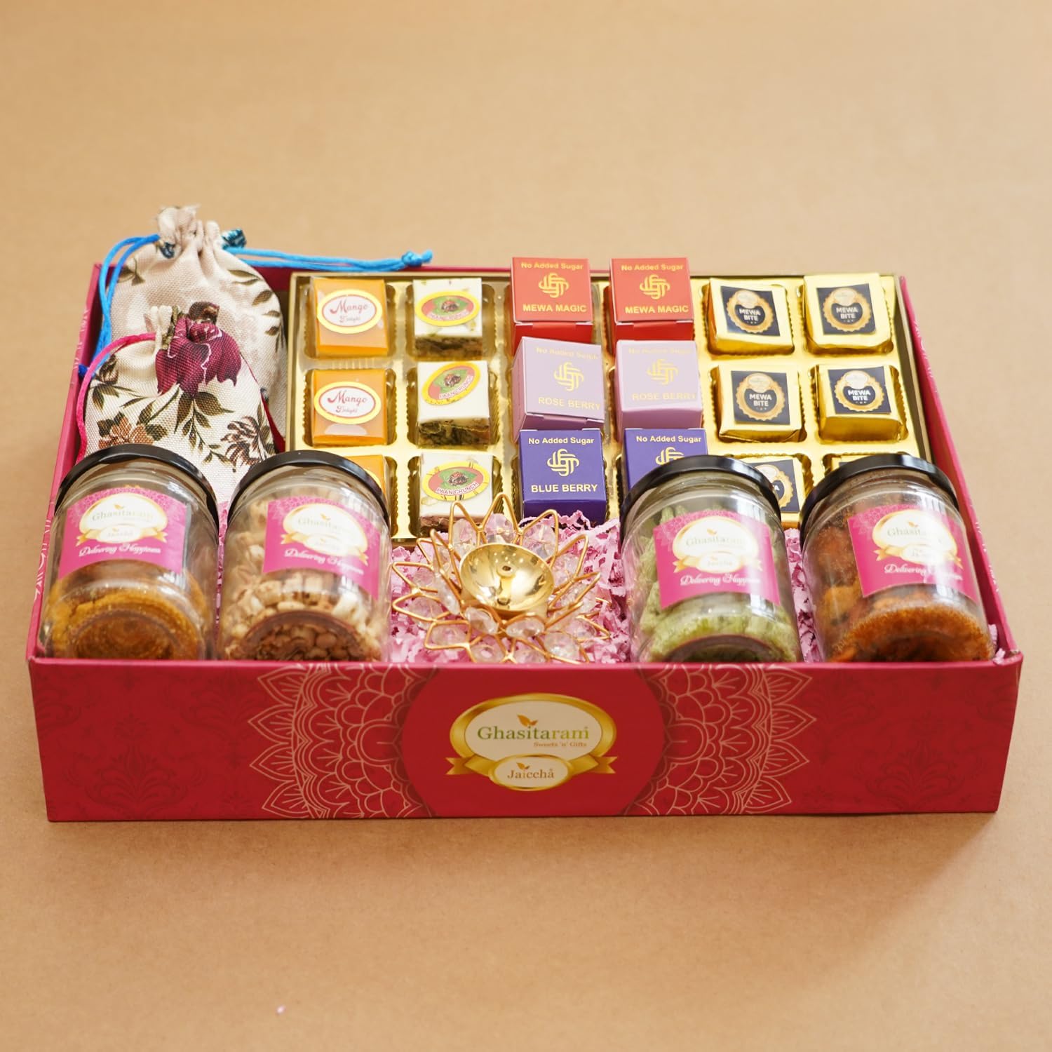 Ghasitaram Gifts Jaiccha Big Pink tray of best bites, jute pouches of mewa bites and anjeer bites, 2 jars of dryfruits, 2 jars of namkeen and diya