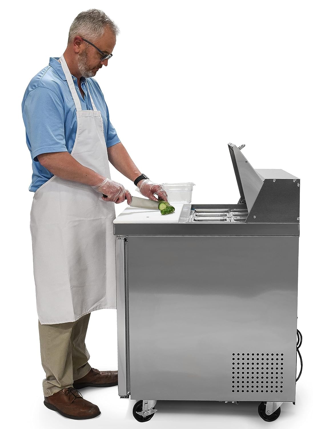 Chef preparing food on the FSE Salad/Sandwich Prep Table