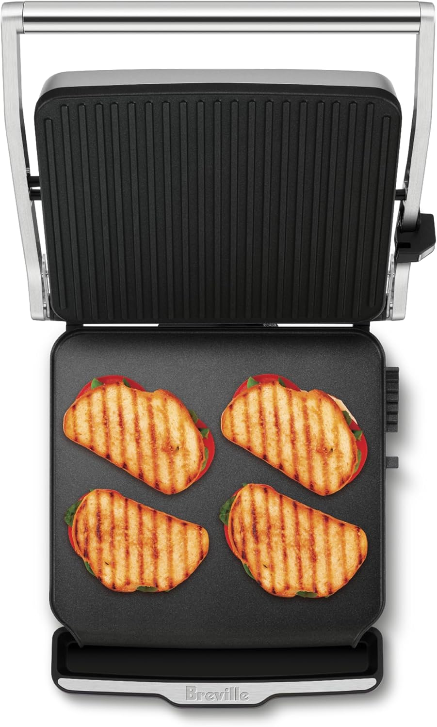 Top view of the Breville AdjustaGrill & Sear open, showing four grilled sandwiches on the cooking plates.
