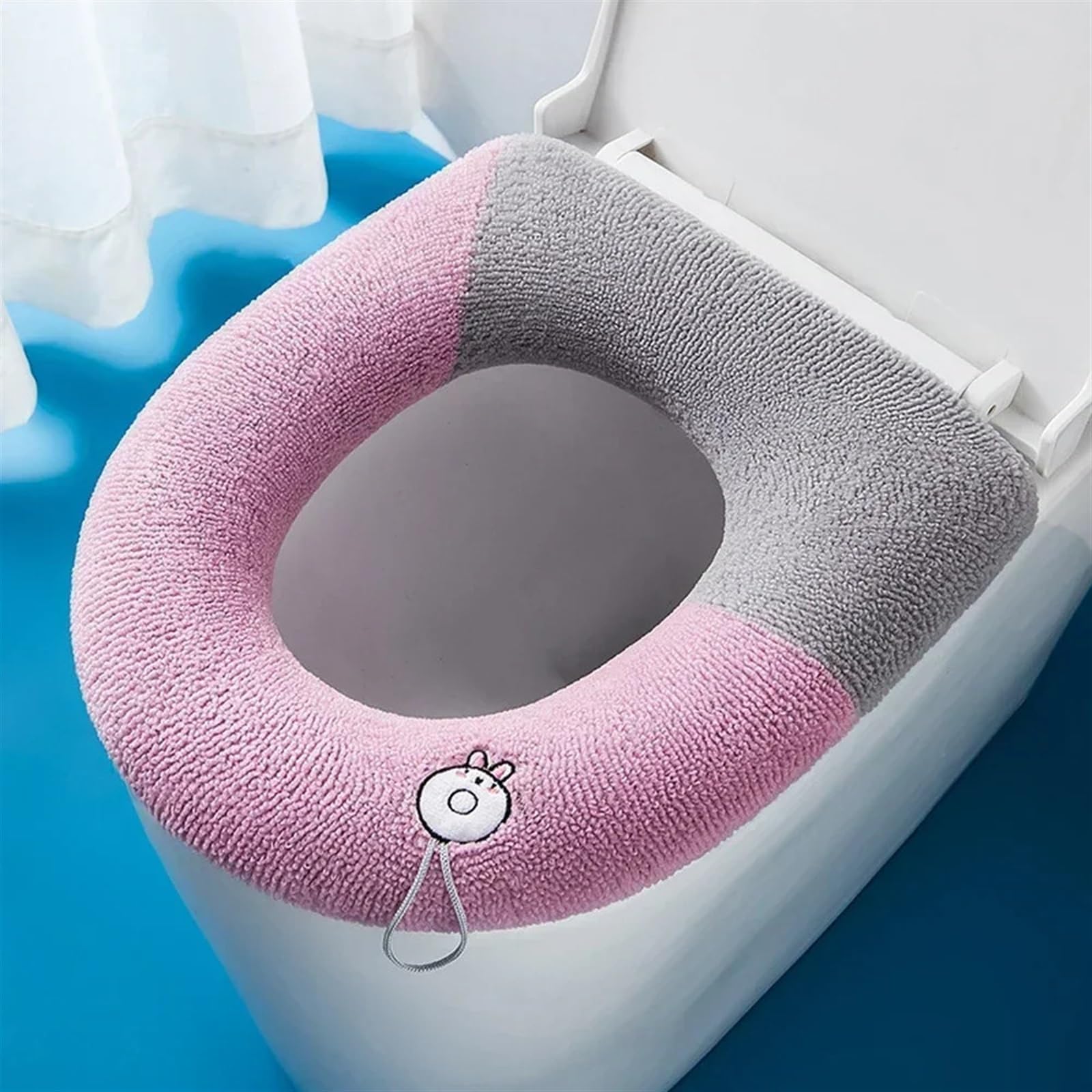 Funda de asiento de inodoro acolchada rosa con asa lavable para aliviar el asiento rígido
