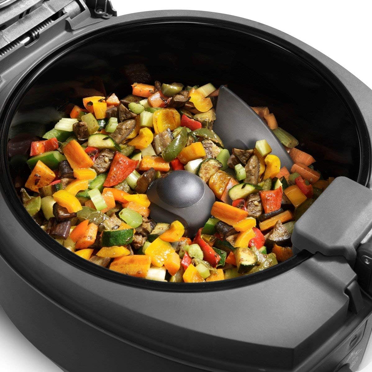 Mixed diced vegetables cooking in the De'Longhi MultiFry Extra with the automatic mixing paddle active.
