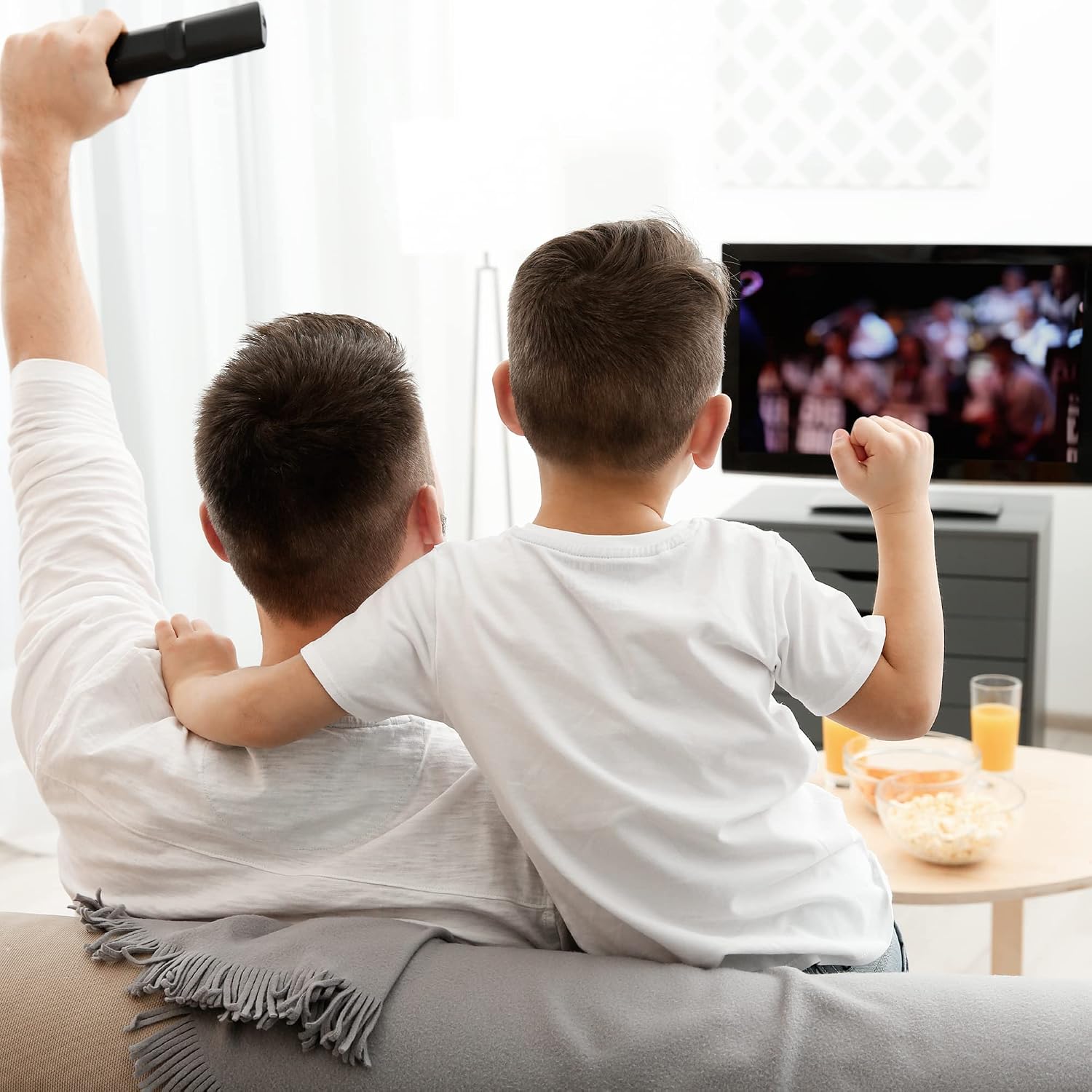 Family watching TV with a remote control