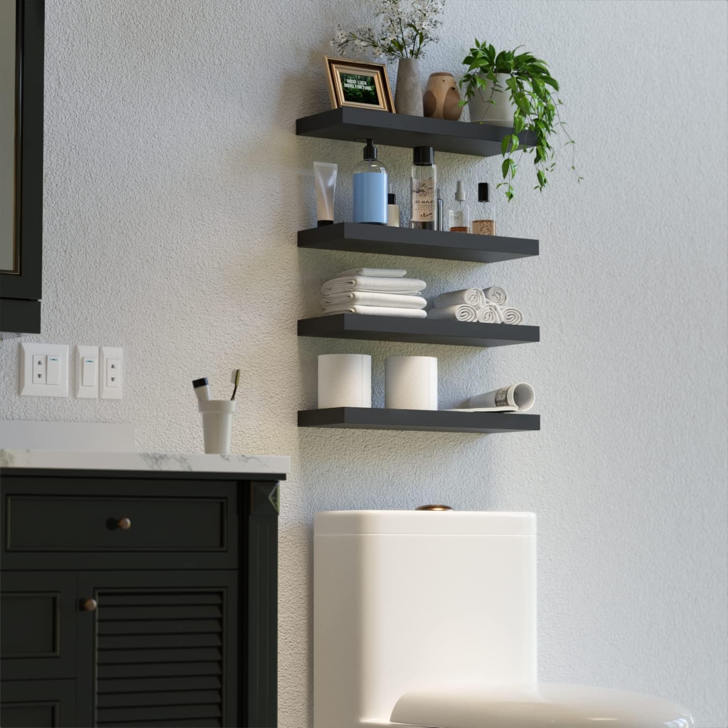 Four black floating shelves installed vertically above a toilet in a bathroom, holding toiletries, folded towels, and toilet paper.