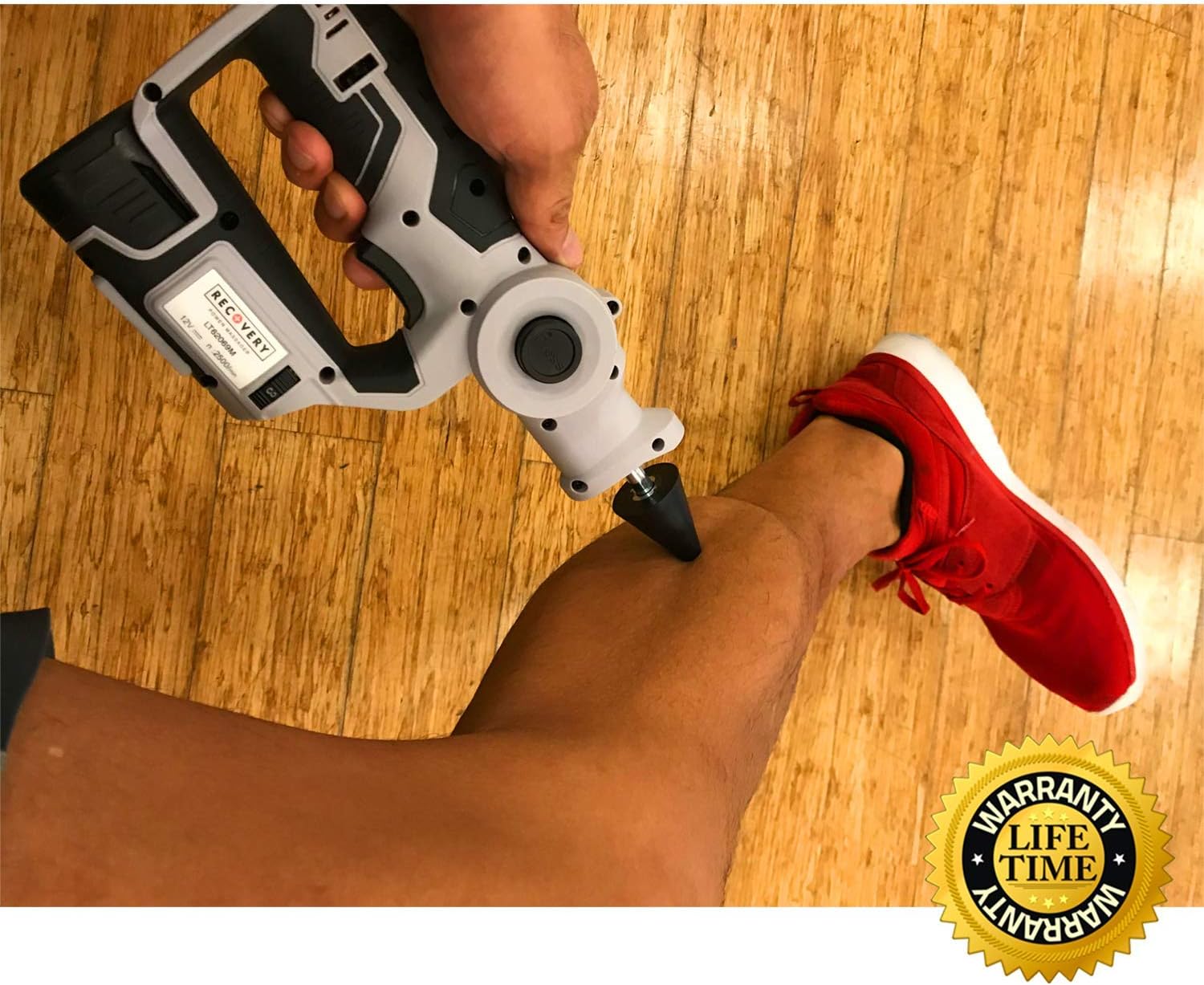 A person using the Recovery Ultimate Deep Tissue Massager on their calf muscle.