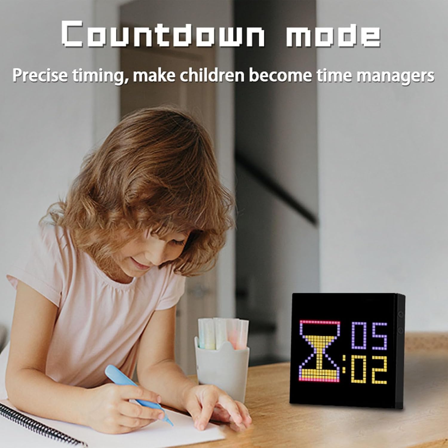 A child drawing at a desk with the Fockety LED Pixel Display showing a countdown timer