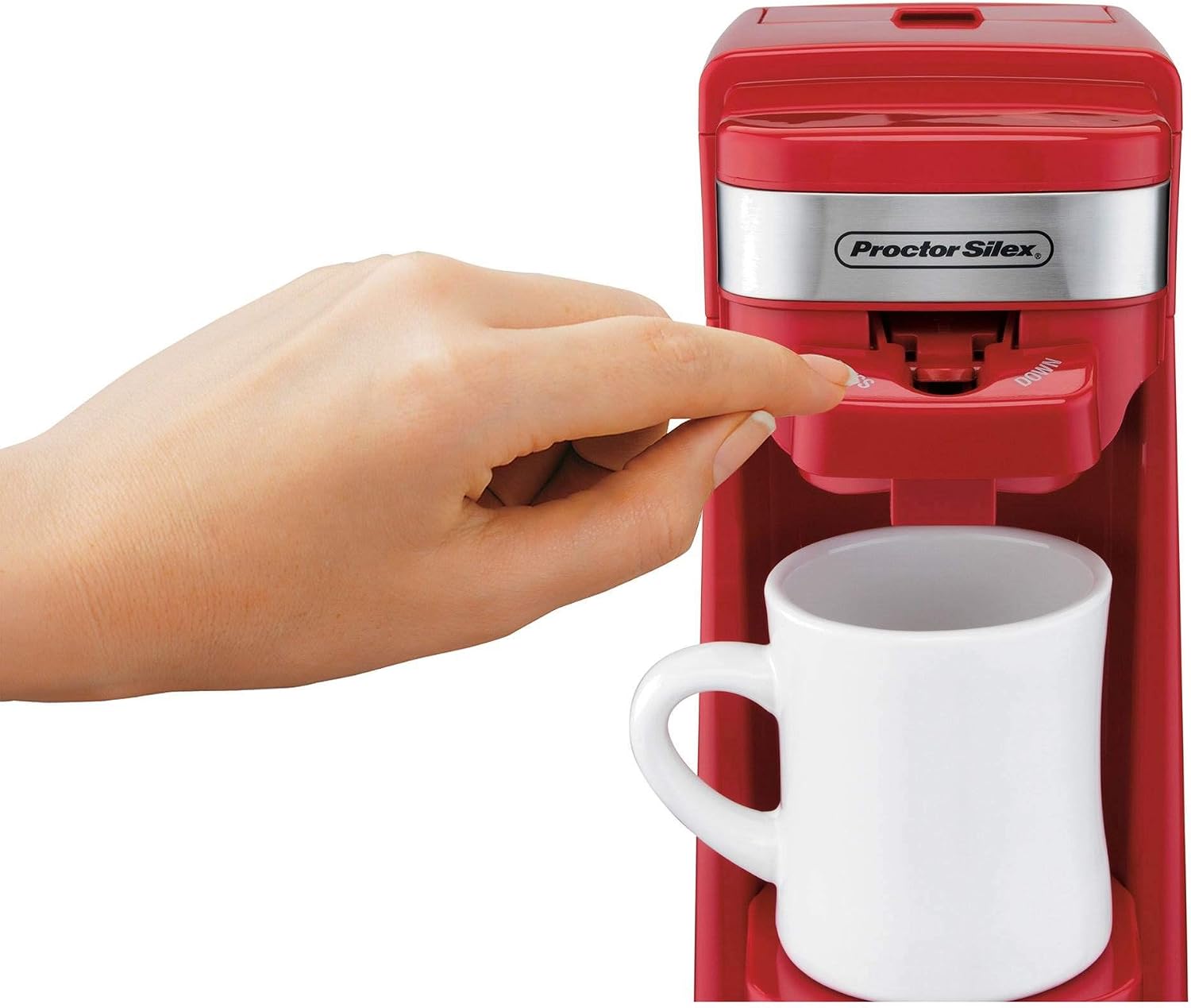 A hand pressing the brew button on the Proctor Silex FlexBrew coffee maker.