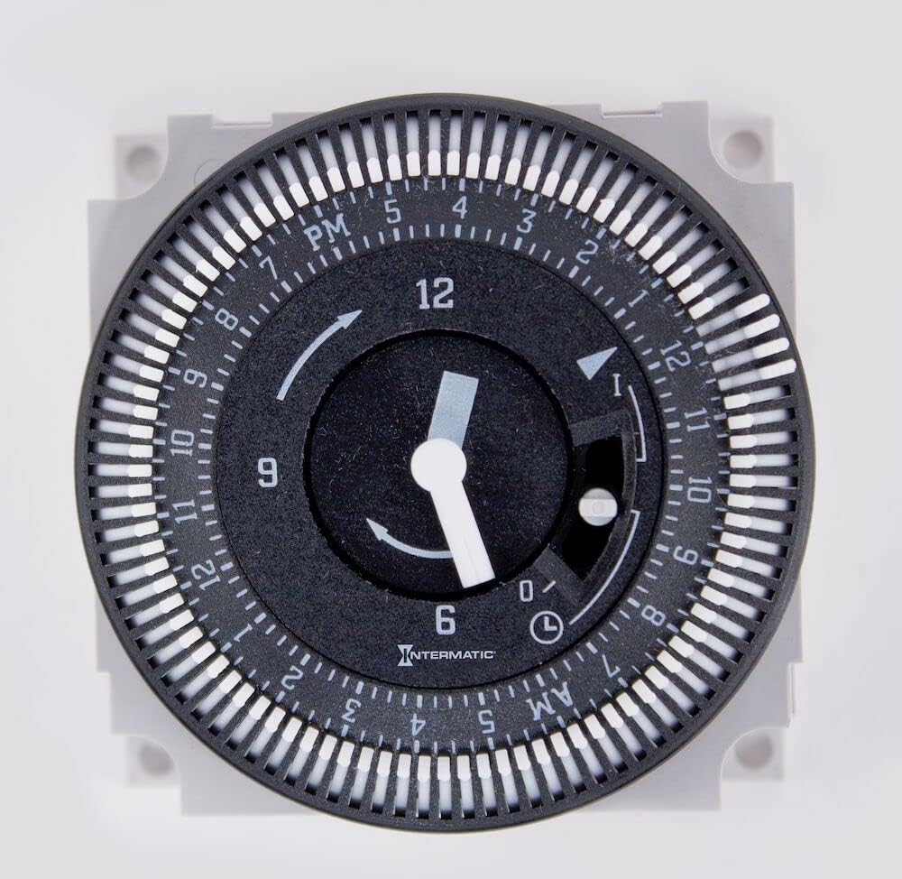 Close-up view of the Intermatic GM40AV timer dial with AM/PM indicators and 15-minute segments.