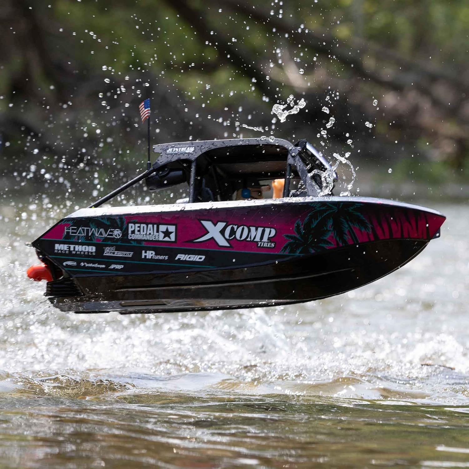 Pro Boat 1/6 Jetstream Brushless 24 Shreddy RTR Boat launching off a small wave, showing its robust hull design.