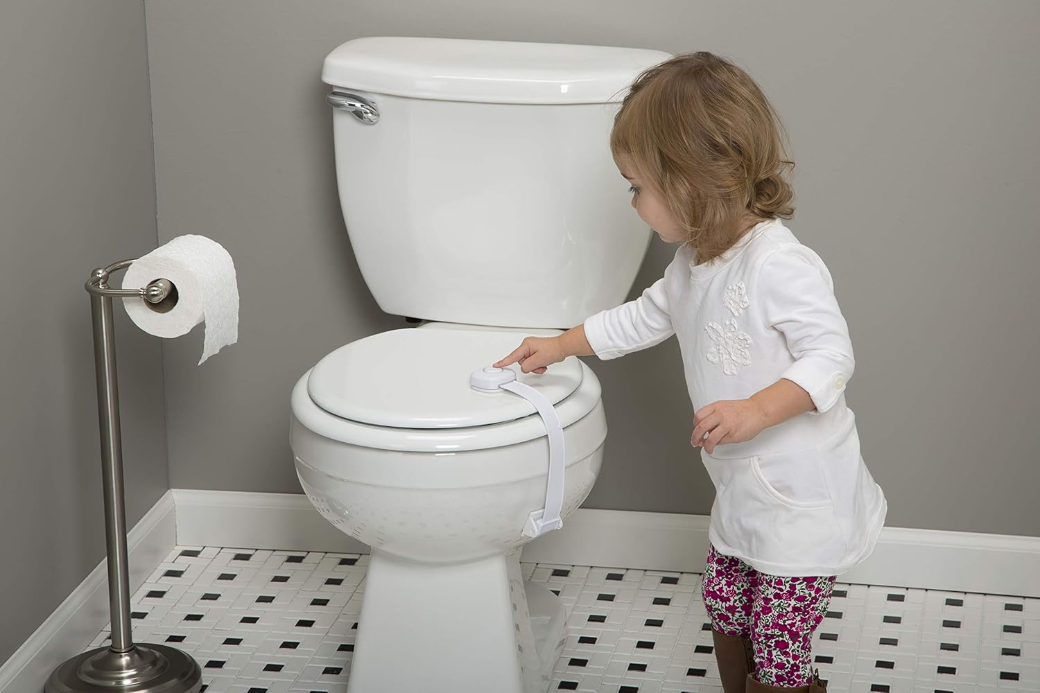 Child attempting to open the toilet lid lock