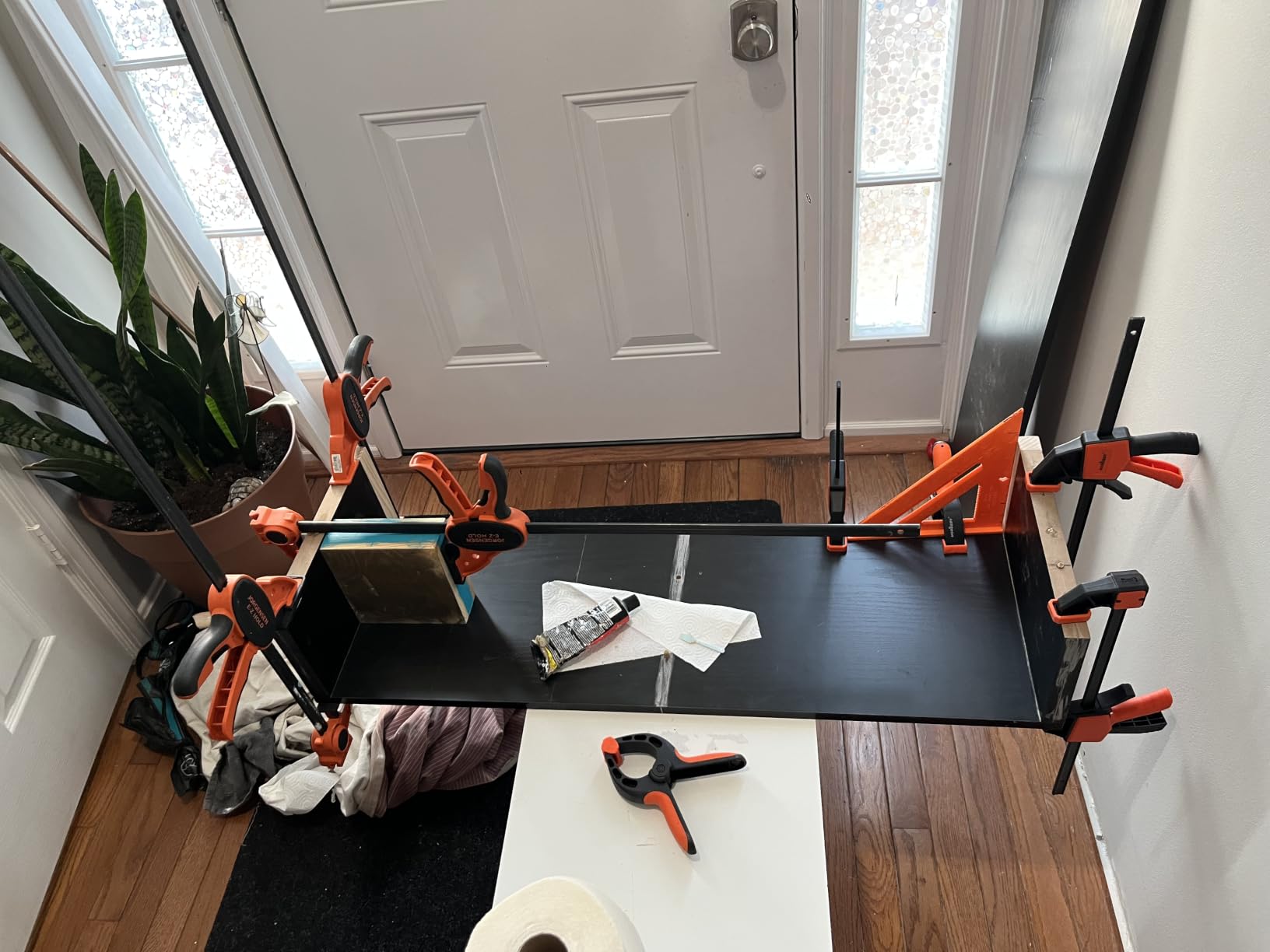 Set of bar clamps holding wood boards together for glue-up