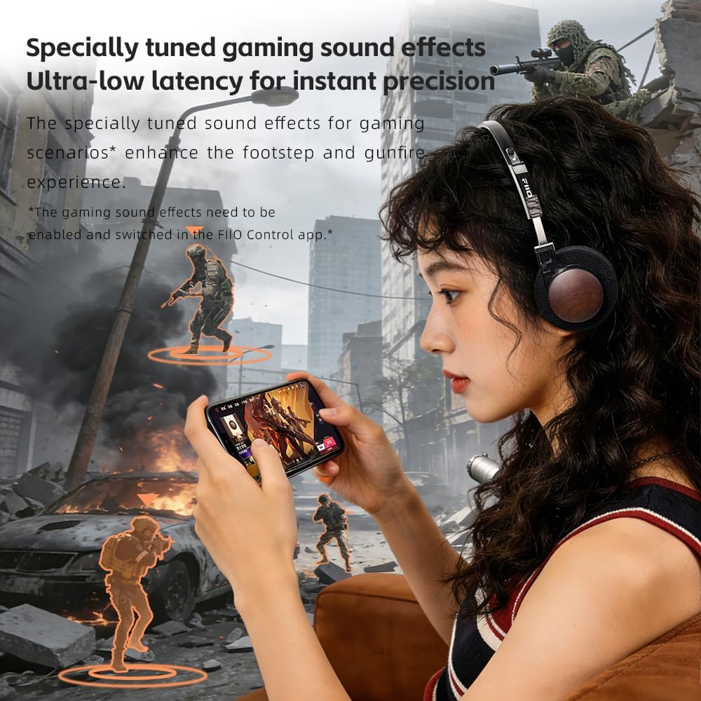 Person playing a mobile game with FiiO EH11 headphones, illustrating gaming sound effects