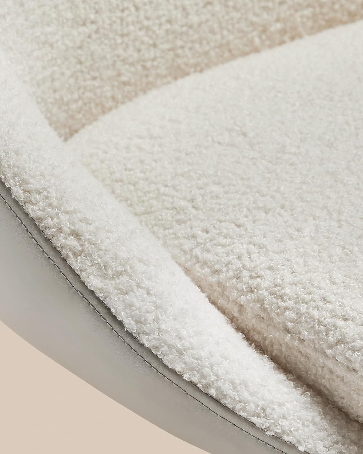 Agara nso view of the cream white fleece fabric and the PU leather trim of the VASAGLE LJB100W01 chair, highlighting the texture and stitching.