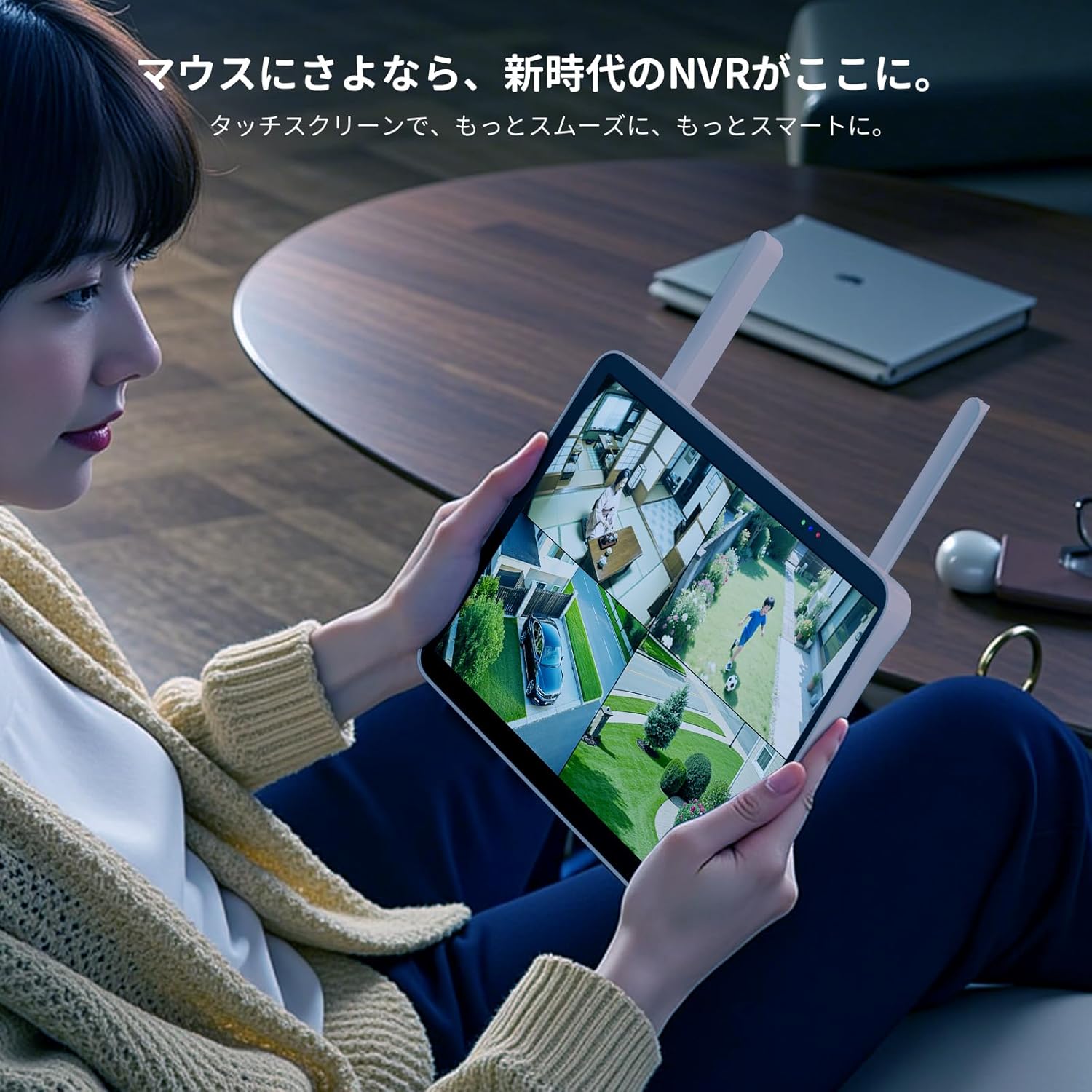 A person using the 10.1-inch touchscreen NVR to view multiple live camera feeds from their property.