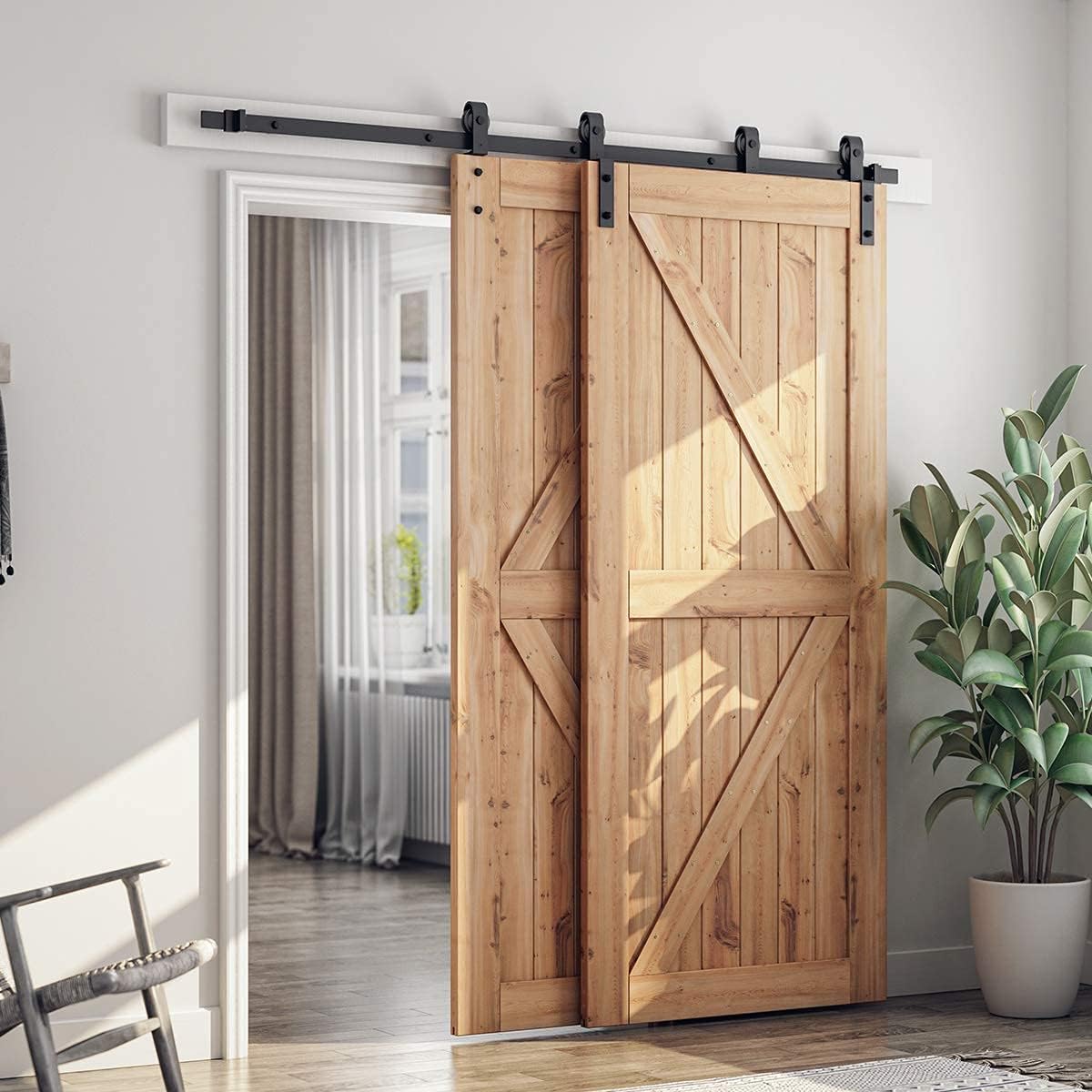 Two wooden barn doors installed with the bypass hardware, one door is partially open revealing a room beyond.