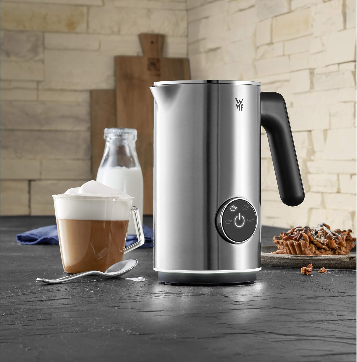 WMF Lumero Milk Frother actively frothing milk, with visible foam inside the container.