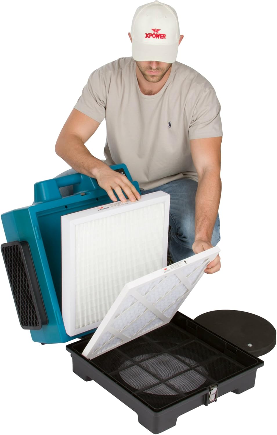 Person replacing filters in XPOWER X-2480A Air Scrubber