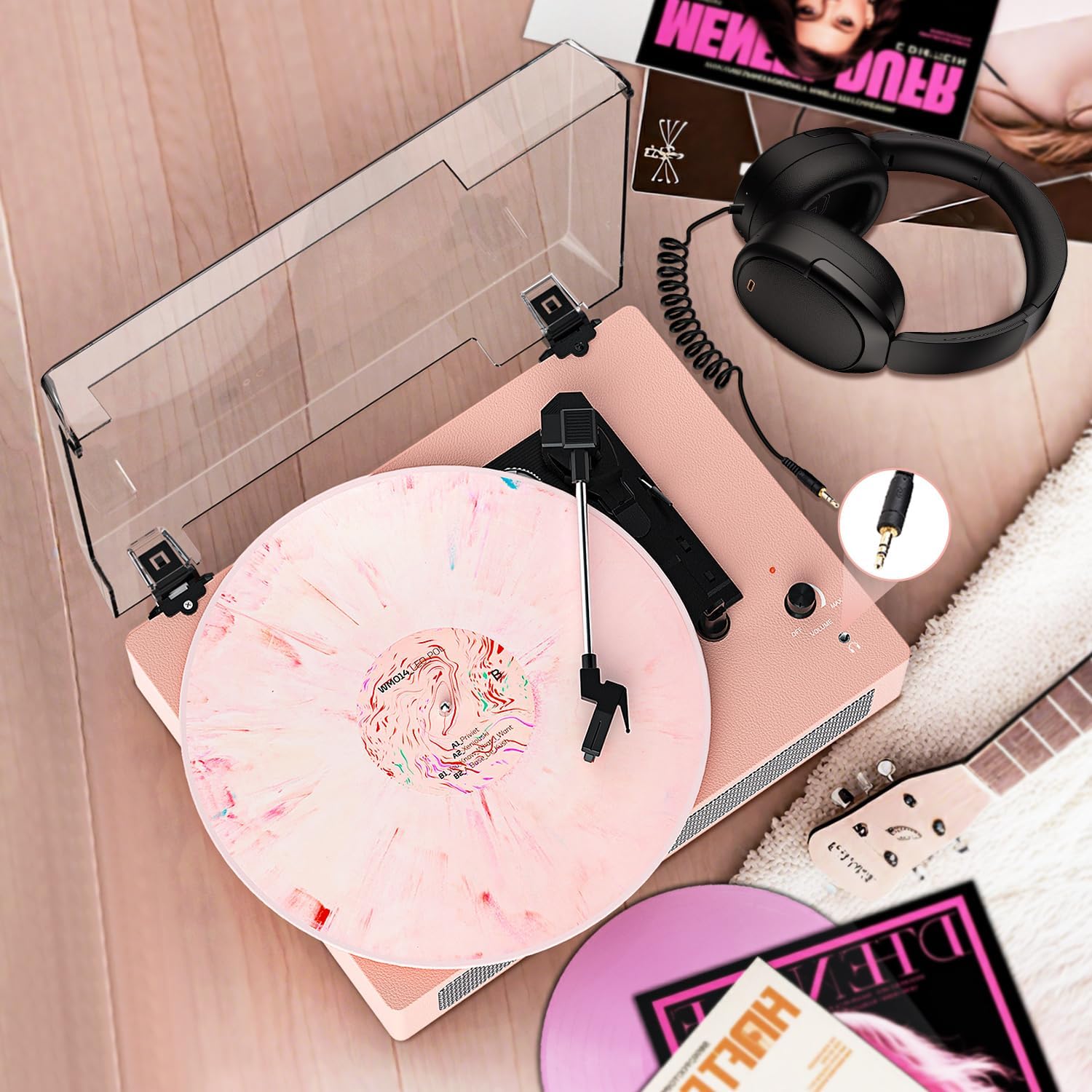 Record player with headphones connected via AUX cable