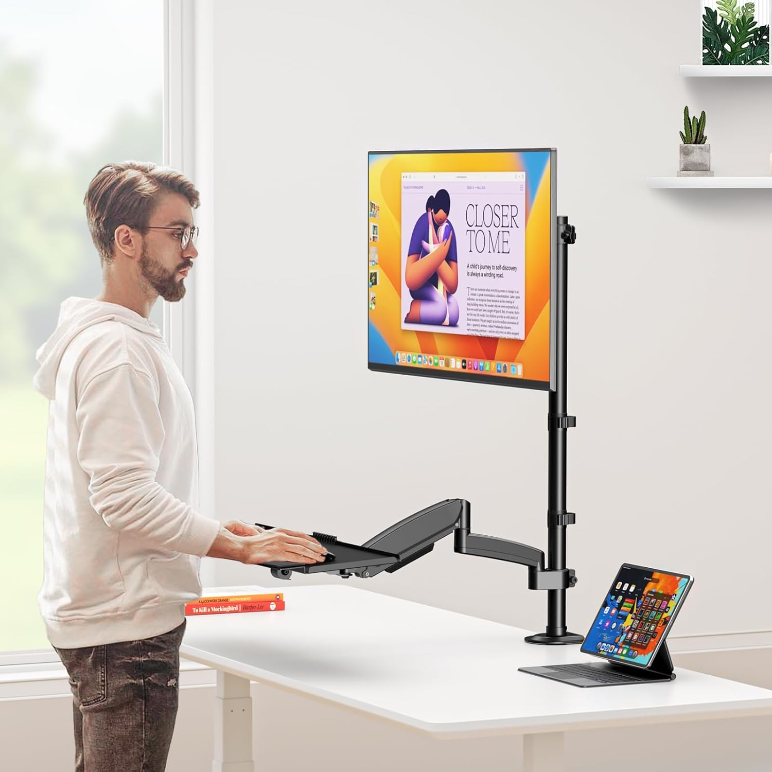 User standing and sitting with the adjustable desk mount