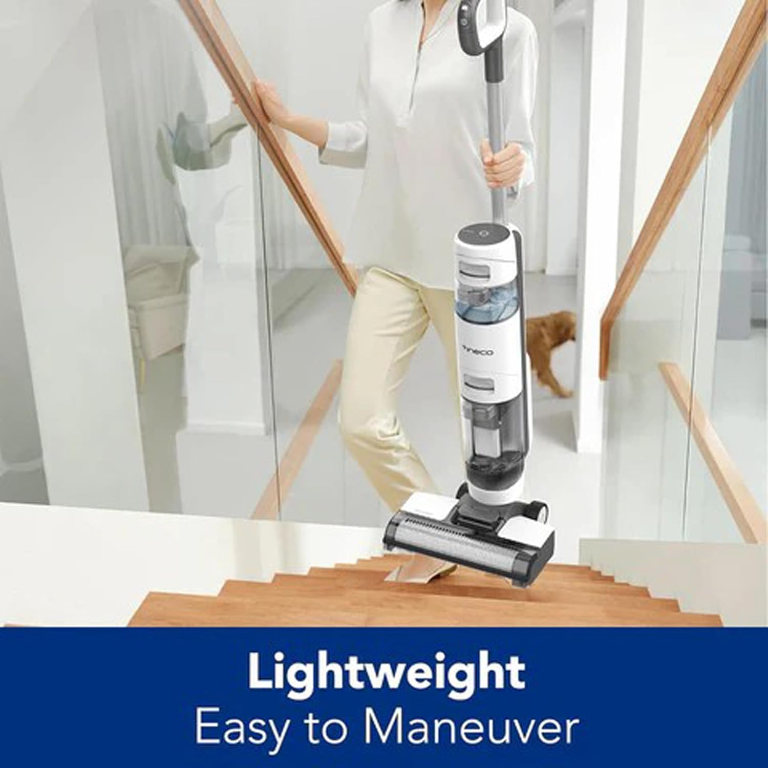 Person carrying Tineco iFLOOR 3 Breeze up stairs